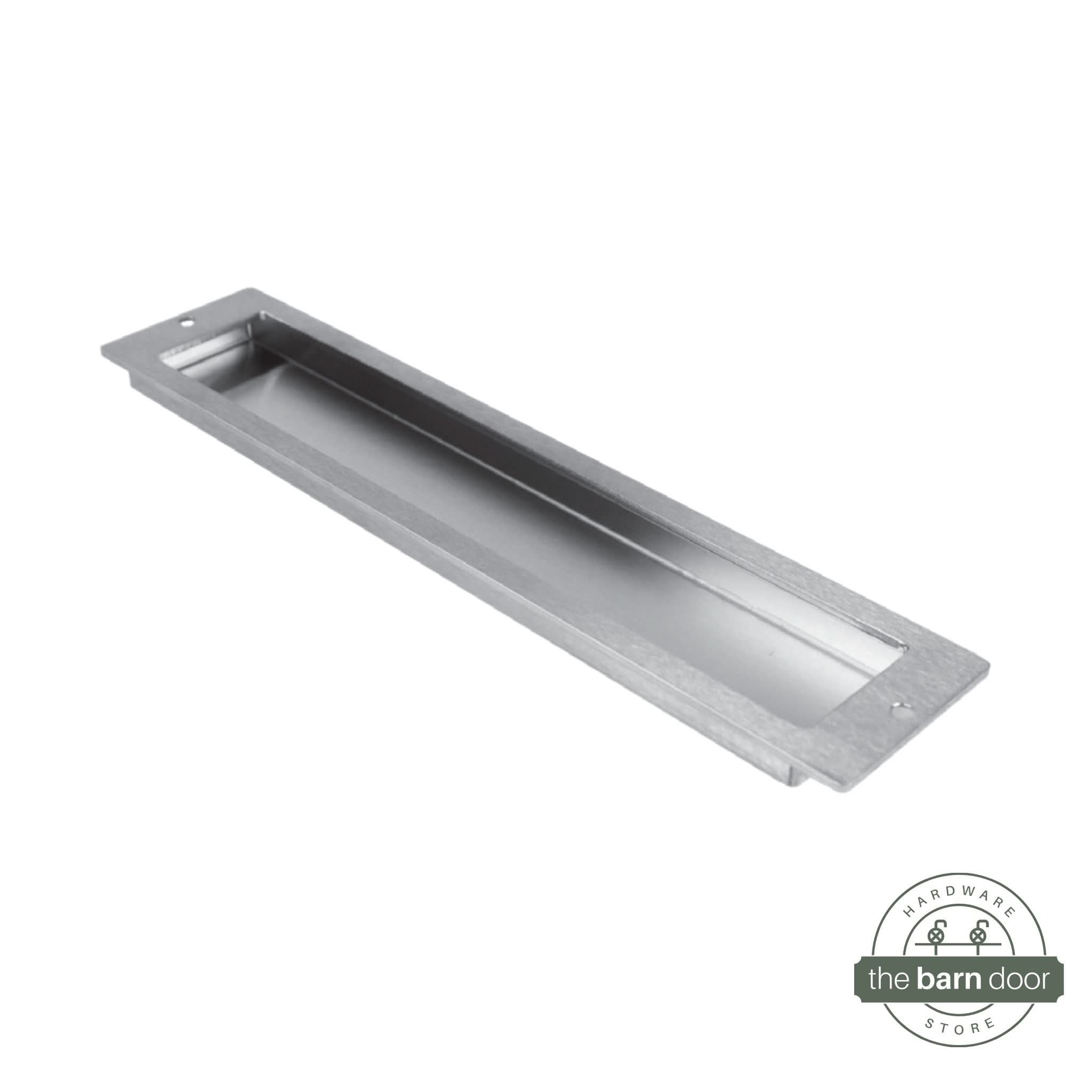 A close-up of a modern, rectangular flush pull handle with sharp, square corners, made from brushed stainless steel.