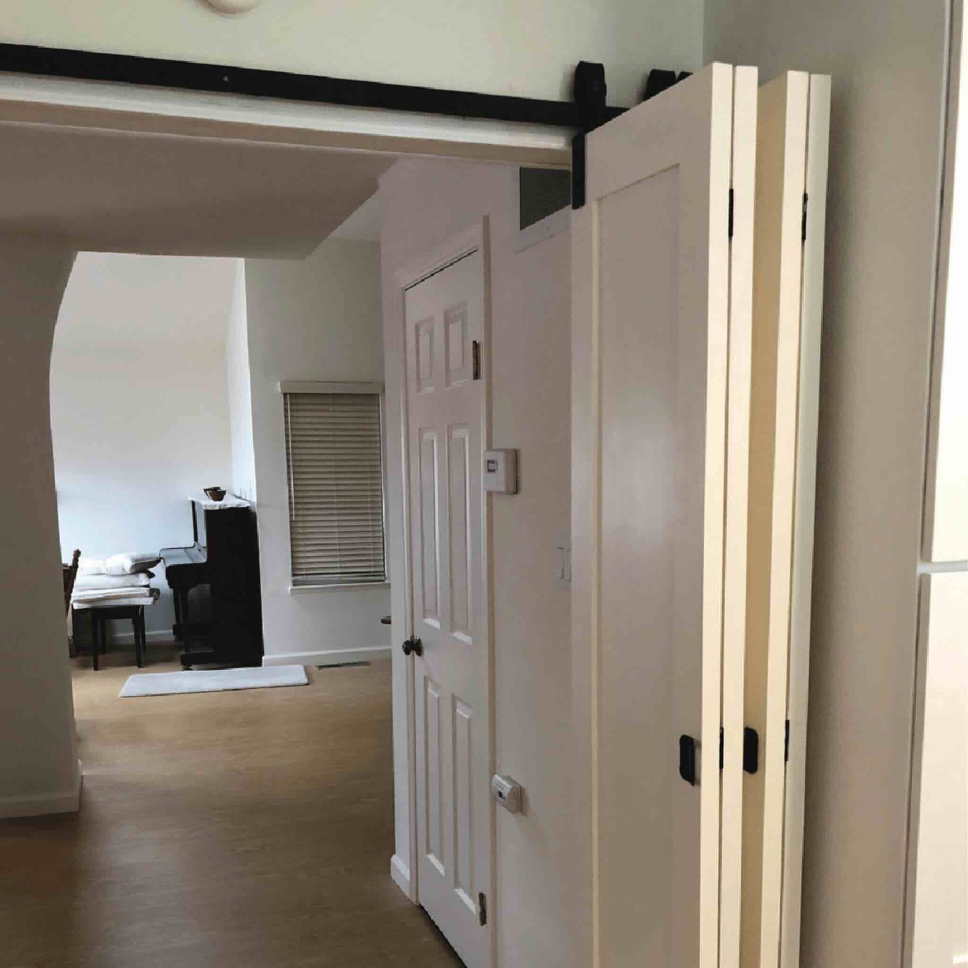 Bifold barn door with track system in a home interior setting