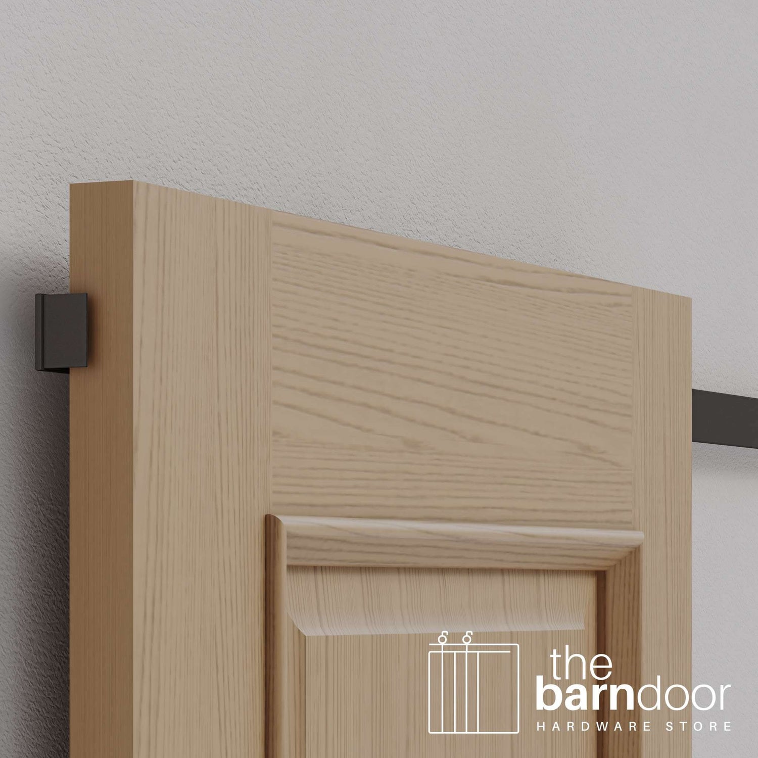 A modern, light wood barn door appears to float against the wall, showcasing the clean aesthetic of the hidden roller barn door hardware.