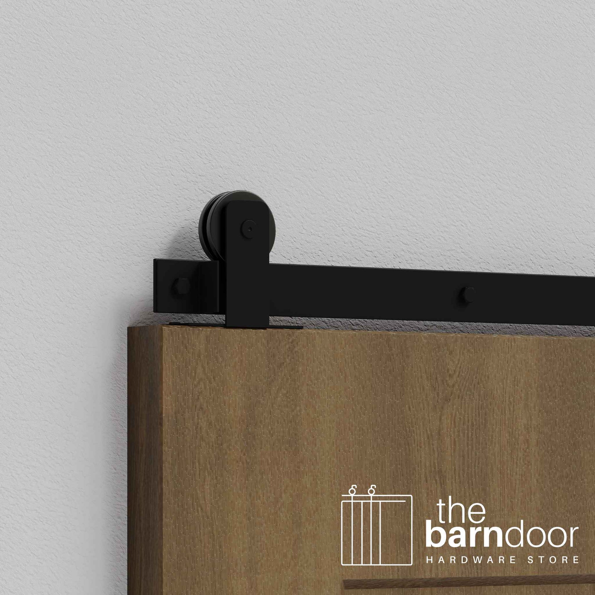 Close-up of Black Straight Top Mount Single Track barn door hardware installed on a wooden door panel.