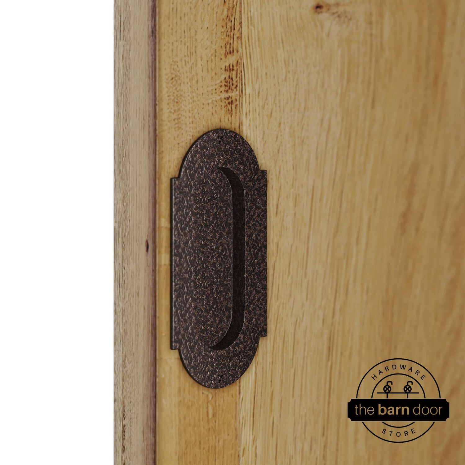 Copper vein flush pull handle with full radius wings mounted on a light oak barn door, brushed silver finish with oval recessed grip and four mounting screws