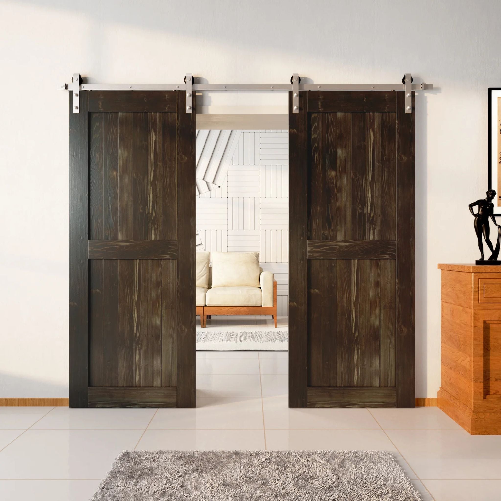 Two wood double barn doors with a two-panel vertical plank design in a very dark, deep Ebony stain, installed with brushed nickel sliding hardware, partially revealing a living room area.