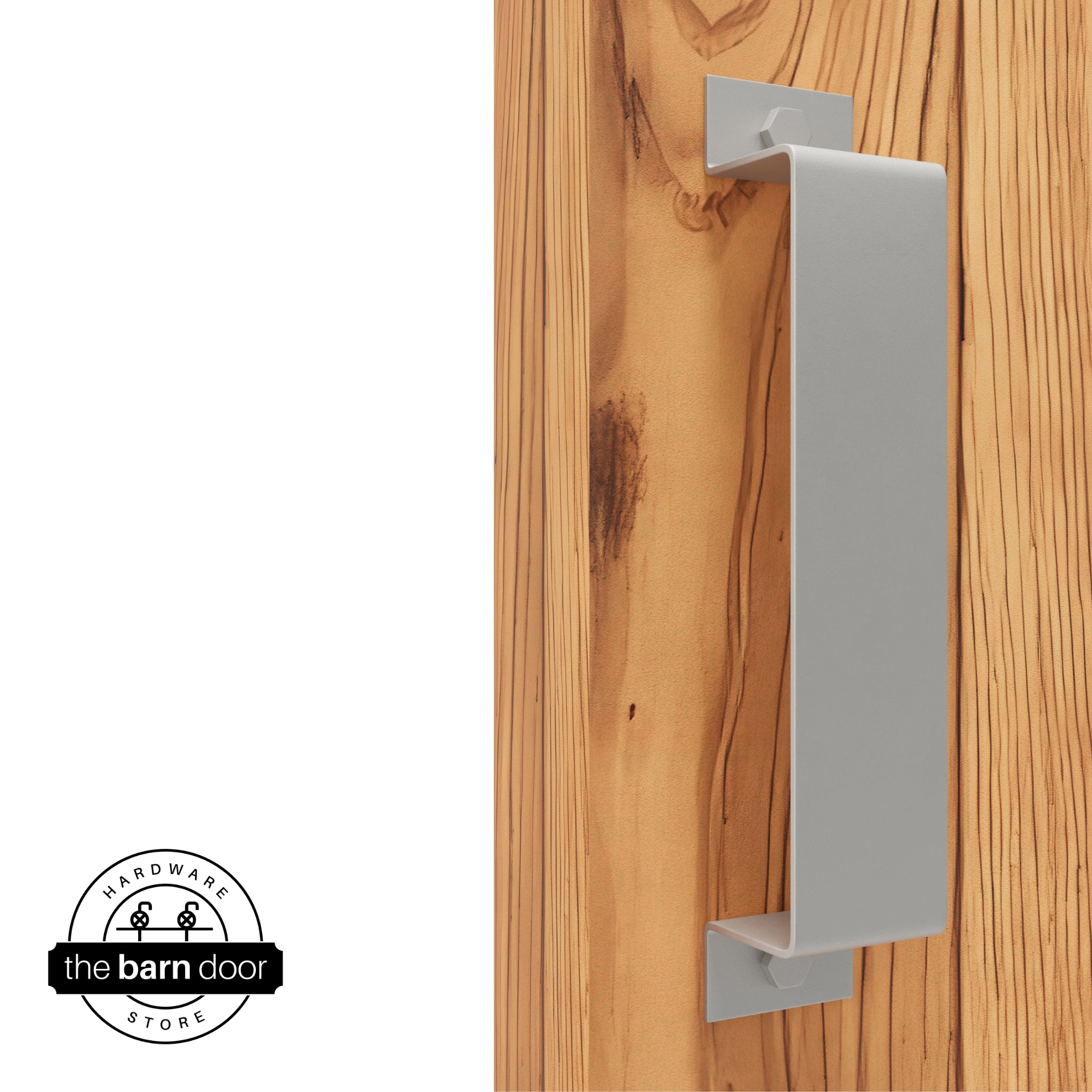 A flint gray, arch-shaped barn door handle is mounted on a light-colored wooden door with a vertical grain pattern.