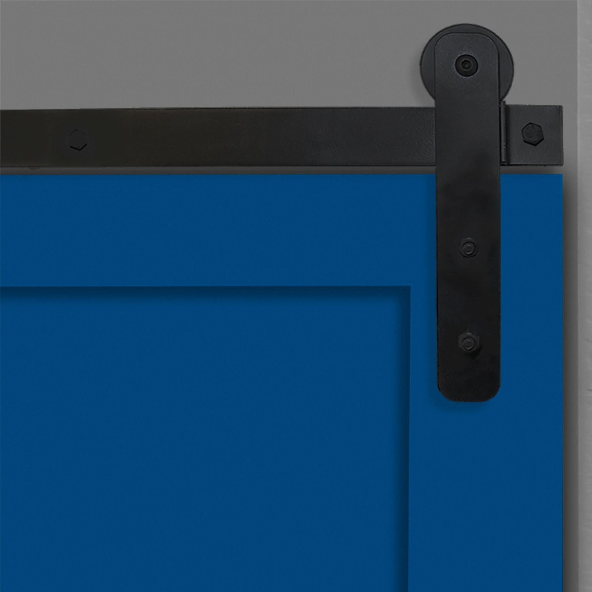 Close-up of Black Straight Strap Single Track barn door hardware installed on a blue door panel.