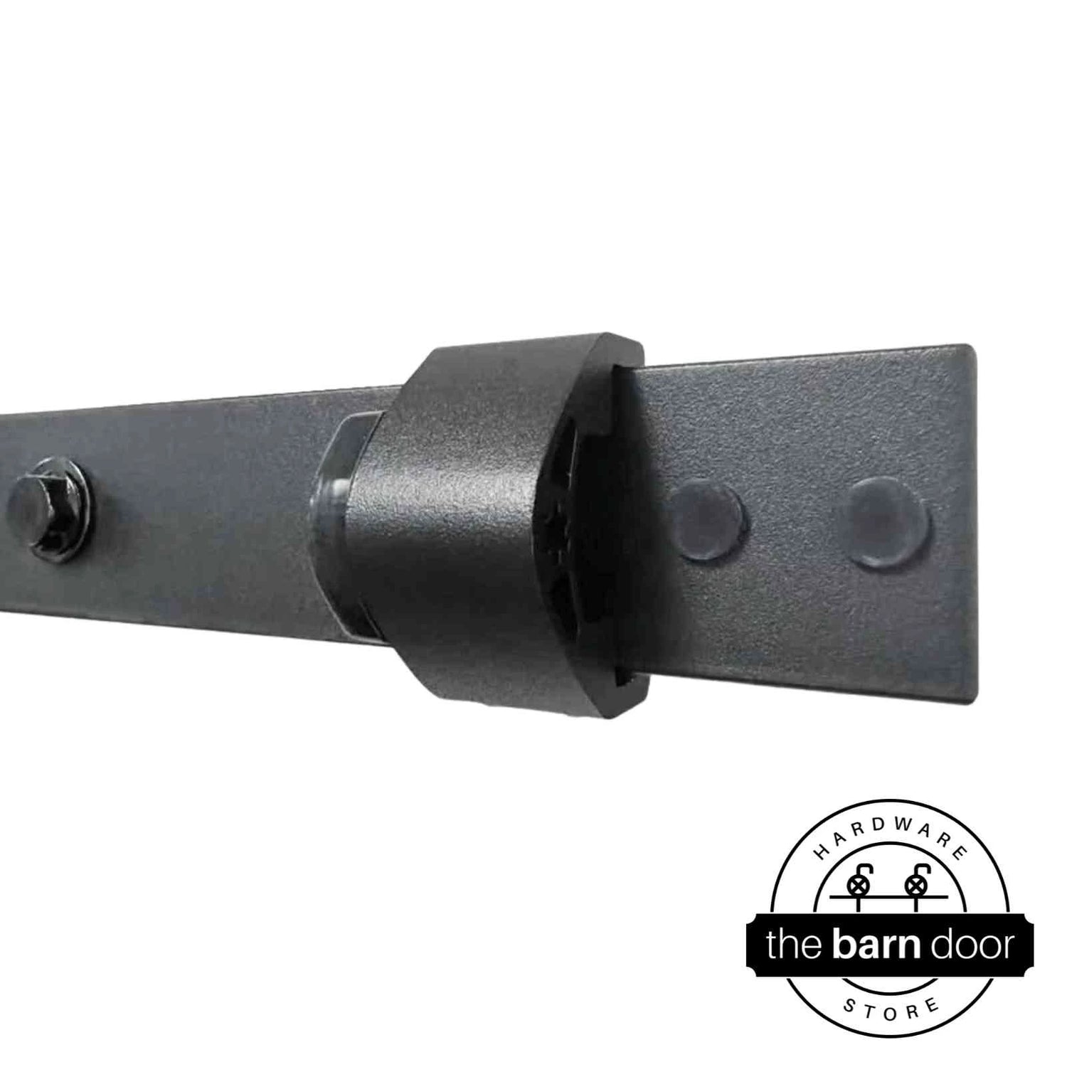 Close-up of an adjustable barn door track stop in matte black mounted to a track, showing installation detail. By The Barn Door Hardware Store.