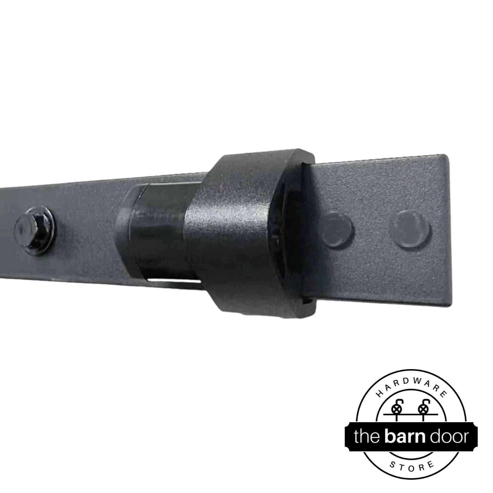 Adjustable barn door track stop mounted on a matte black track, shown installed. By The Barn Door Hardware Store.