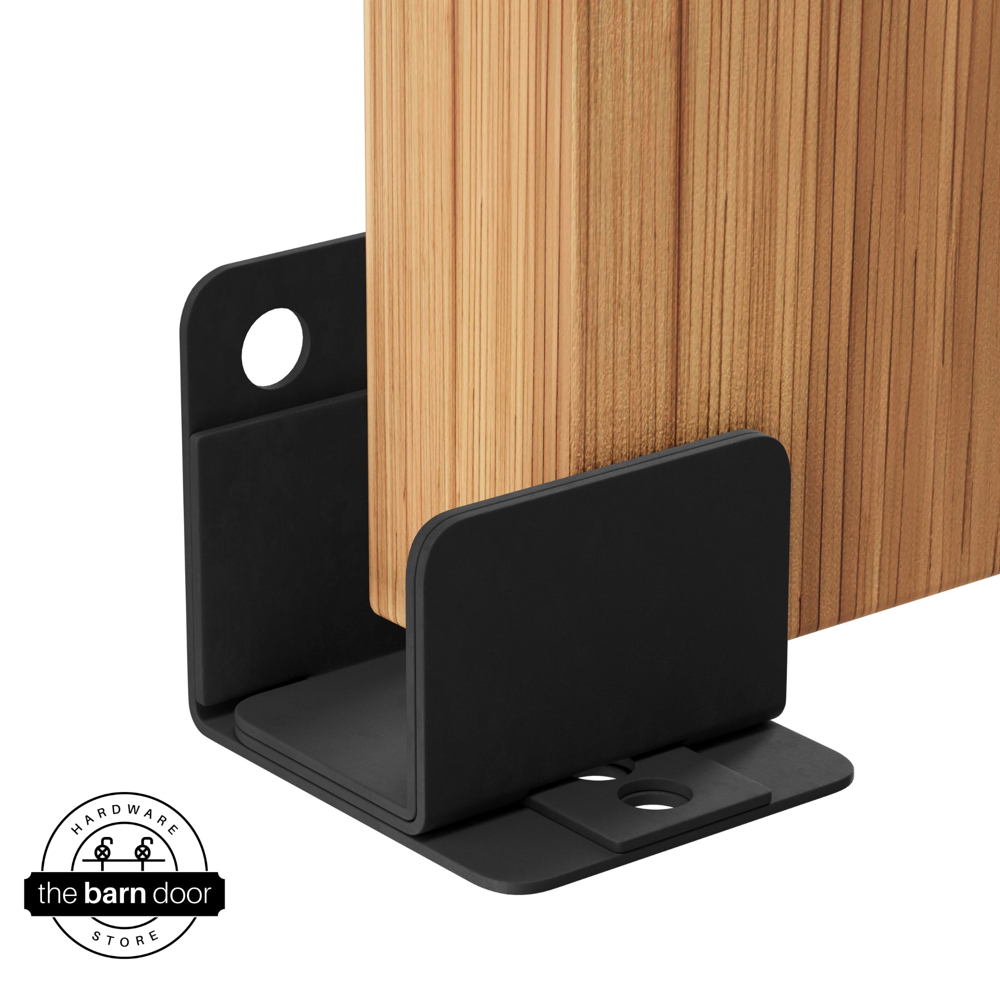 A matte black U-shaped floor guide with a side plate, holding a light wood barn door in place.
