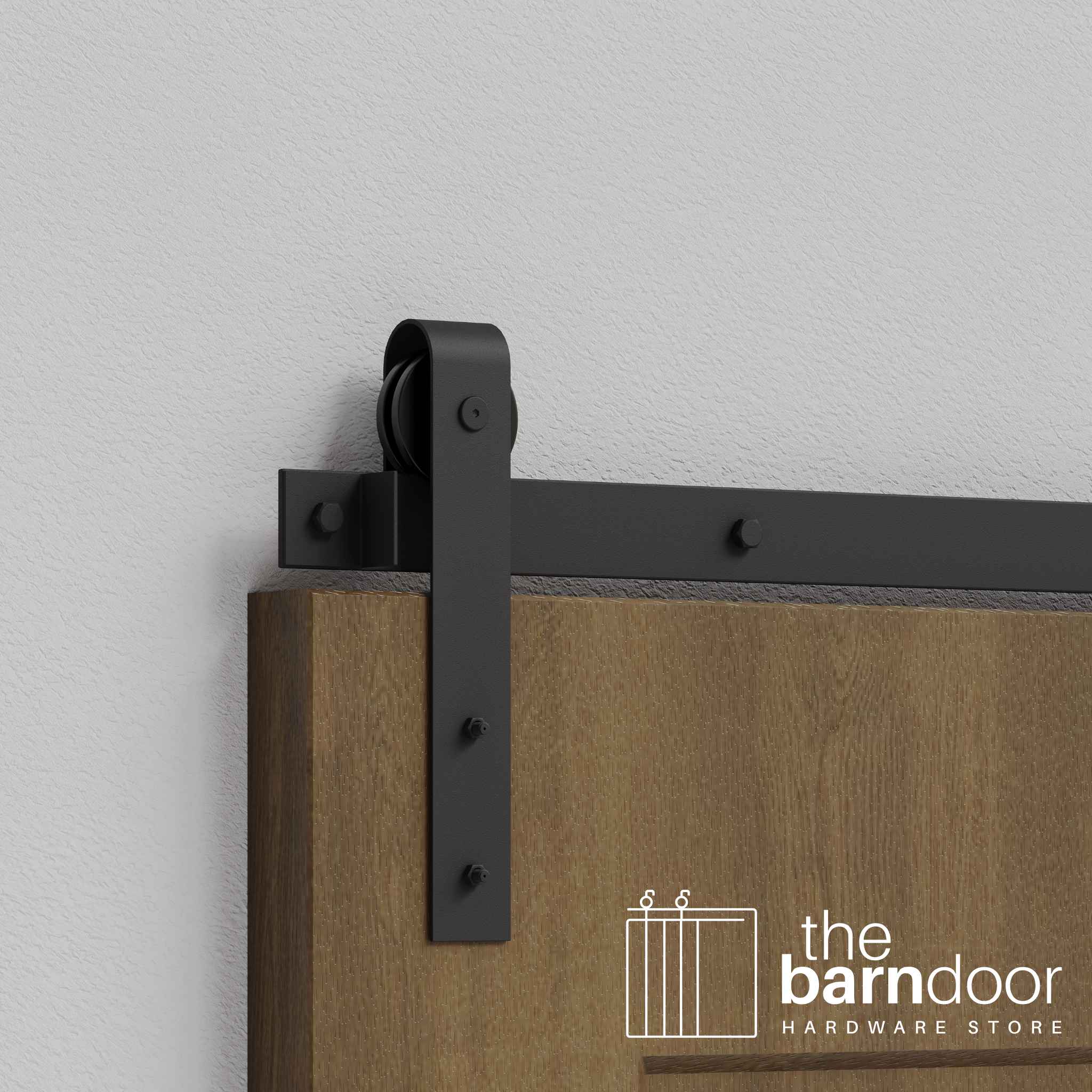 Close-up of Matte Black J-Strap Single Track barn door hardware installed on a wooden door panel.