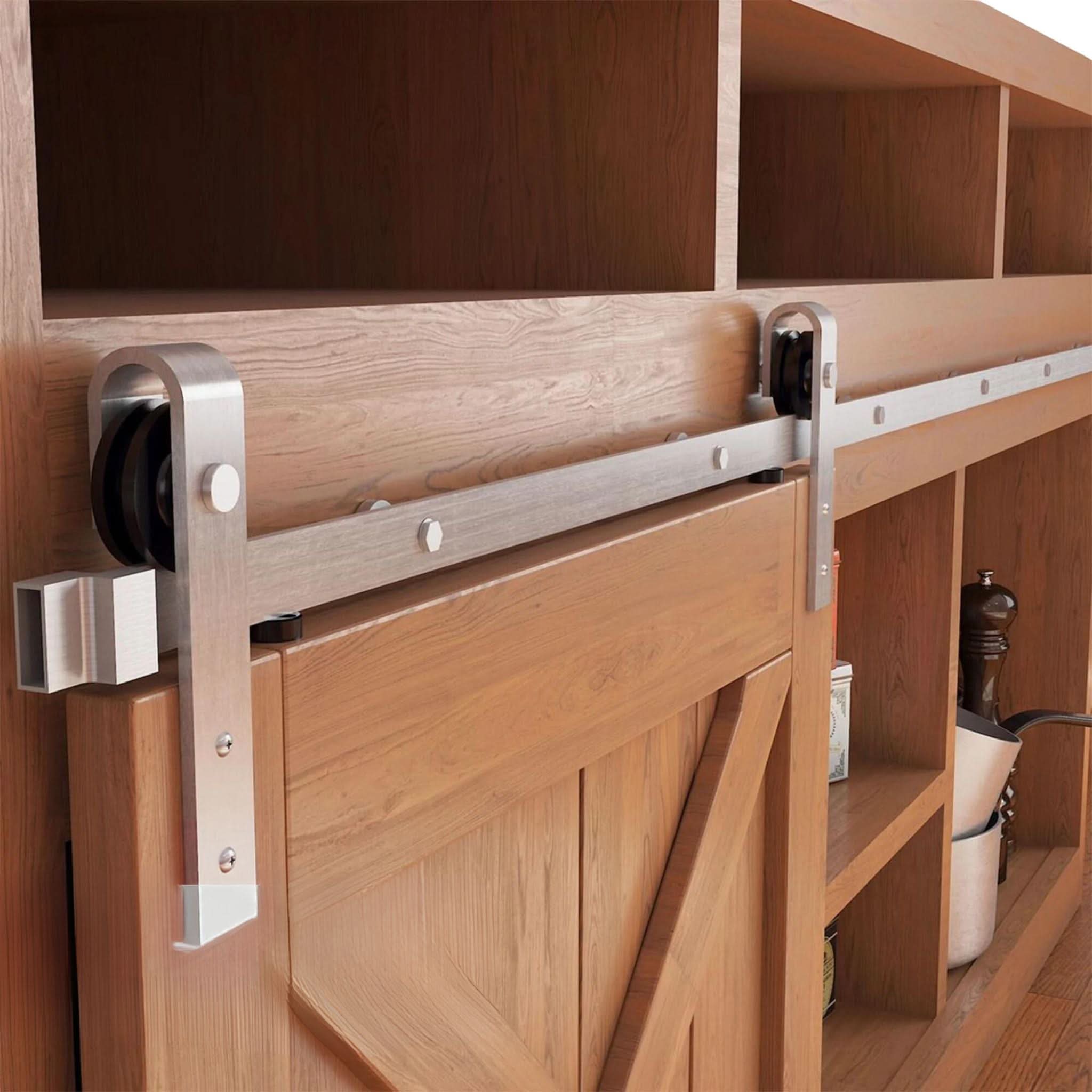 Classic J-Strap cabinet barn door hardware kit in a brushed nickel finish, mounted on a small cabinet door.