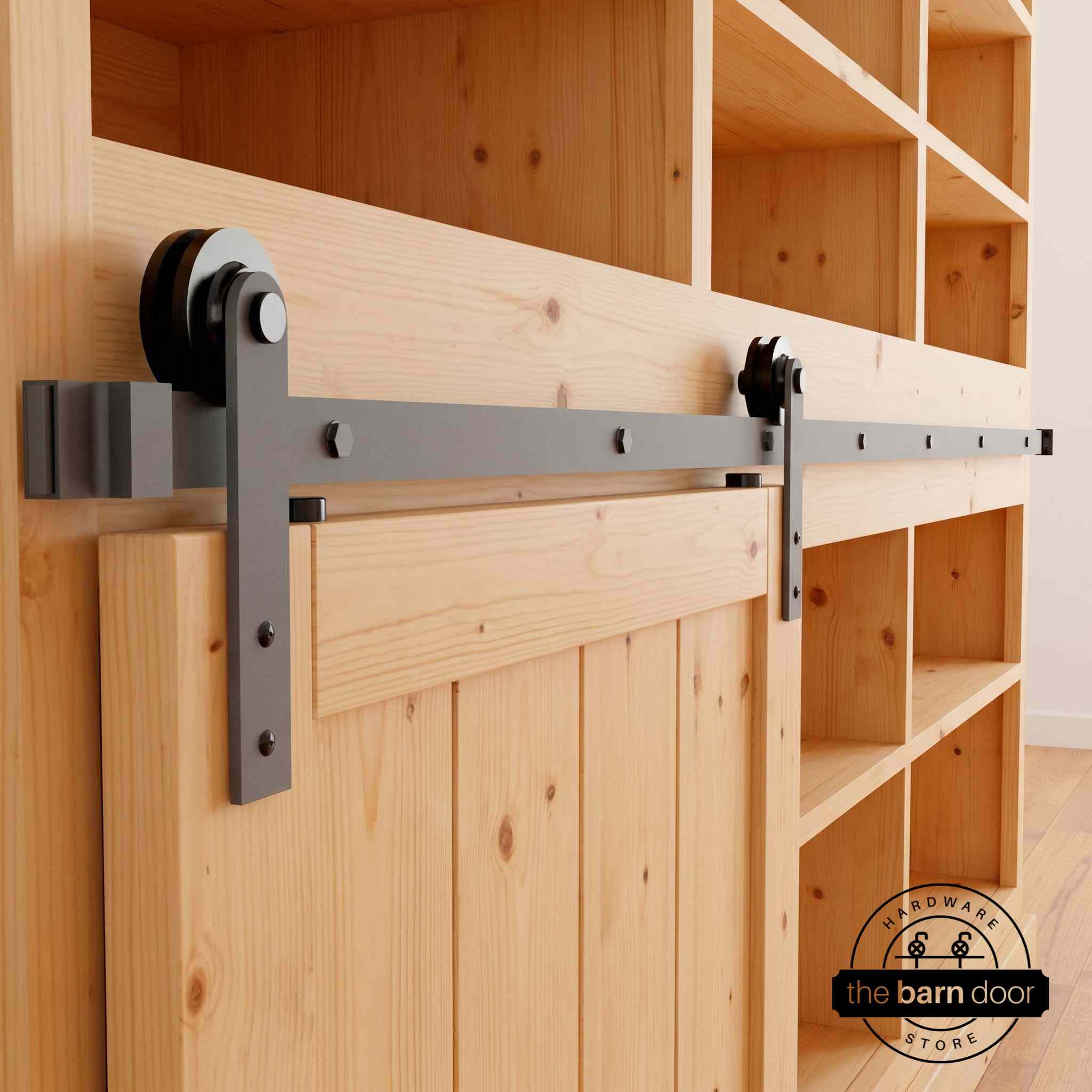 Straight Strap cabinet barn door hardware kit in a matte black finish, mounted on a small cabinet door.