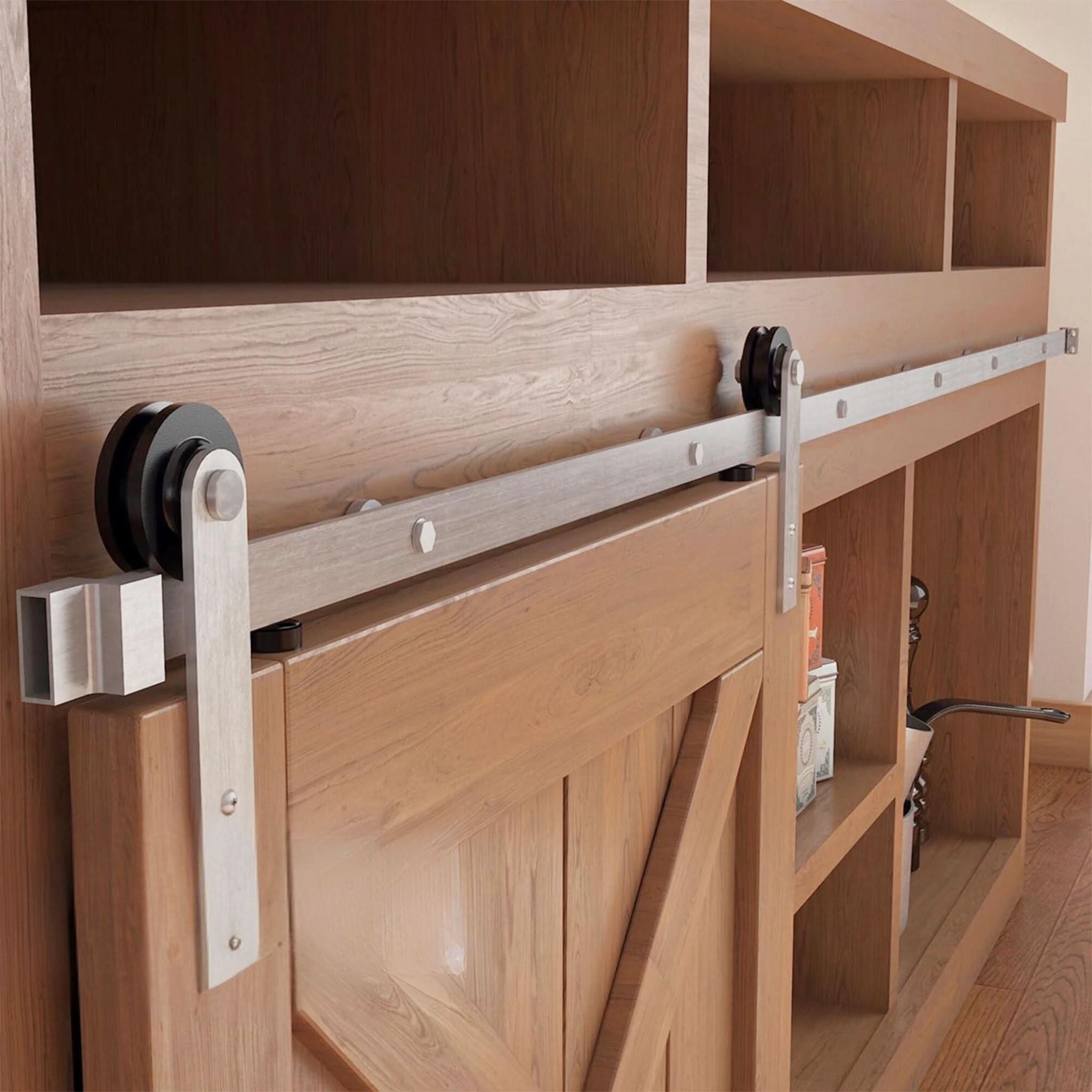A Straight Strap cabinet barn door hardware kit in a brushed nickel finish, mounted on a small cabinet door.