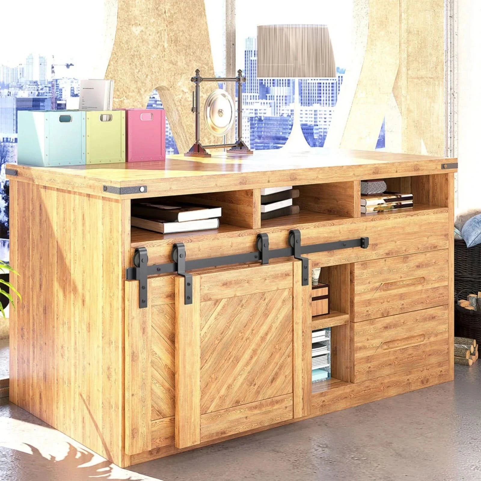 Matte black J-Strap mini bypass cabinet barn door hardware kit on a single track, shown on a small two-door wooden cabinet.