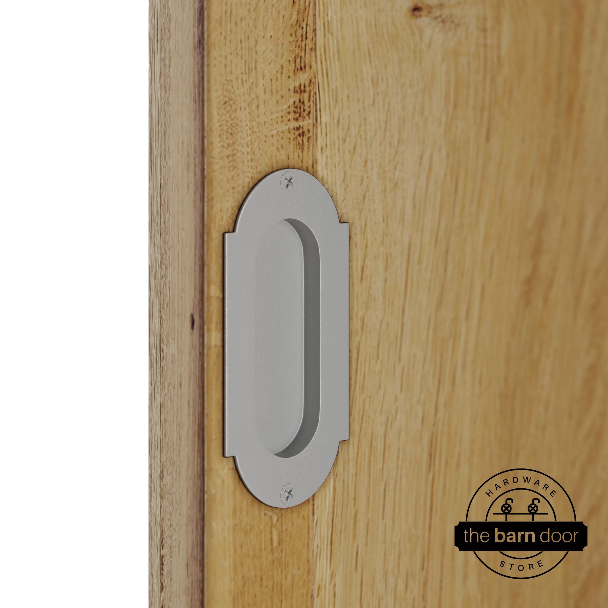 PC Chrome flush pull handle with full radius wings mounted on a light oak barn door, brushed silver finish with oval recessed grip and four mounting screws