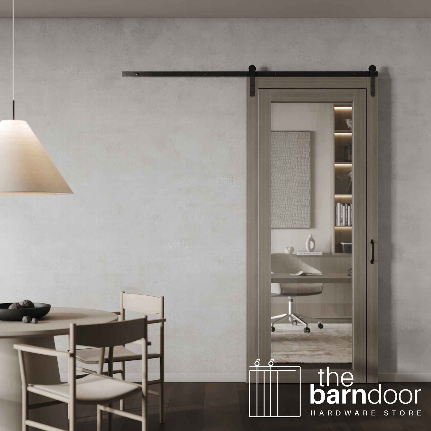 A contemporary glass-panel barn door with single track hardware installed, separating a dining area from a modern home office.