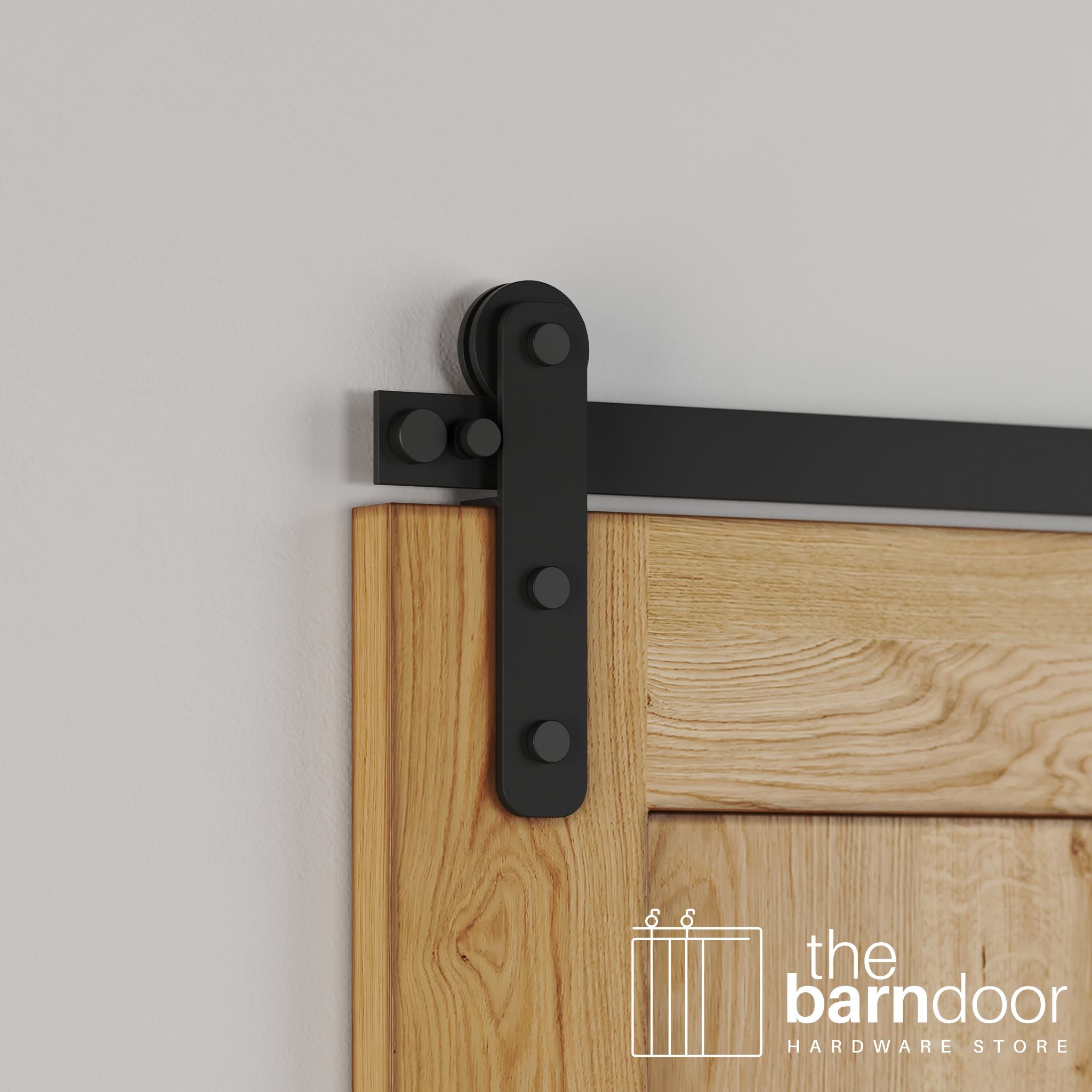 Close-up of Matte Black Stainless Steel Straight Strap barn door hardware installed on a natural oak wood door, emphasizing the clean matte finish and modern strap.