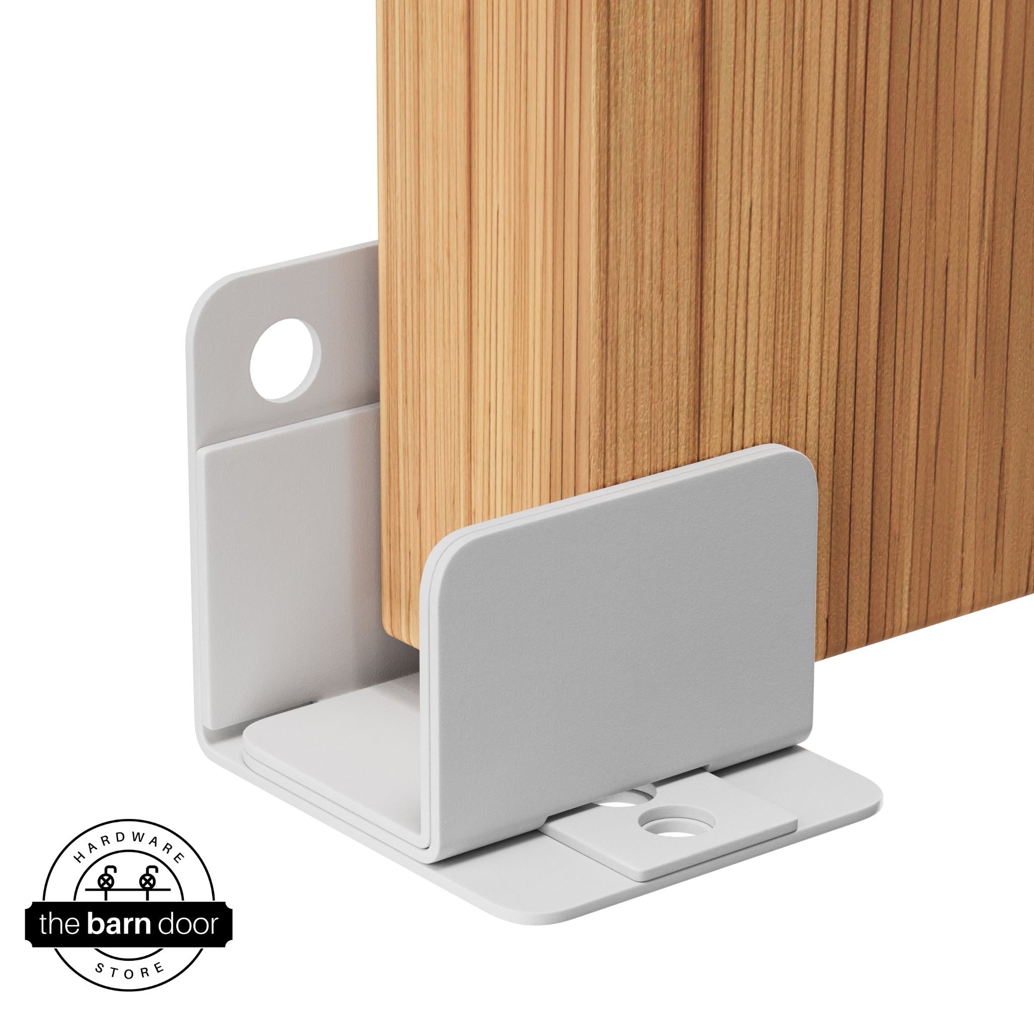 A rocket white U-shaped floor guide with a side plate, holding a light wood barn door in place.