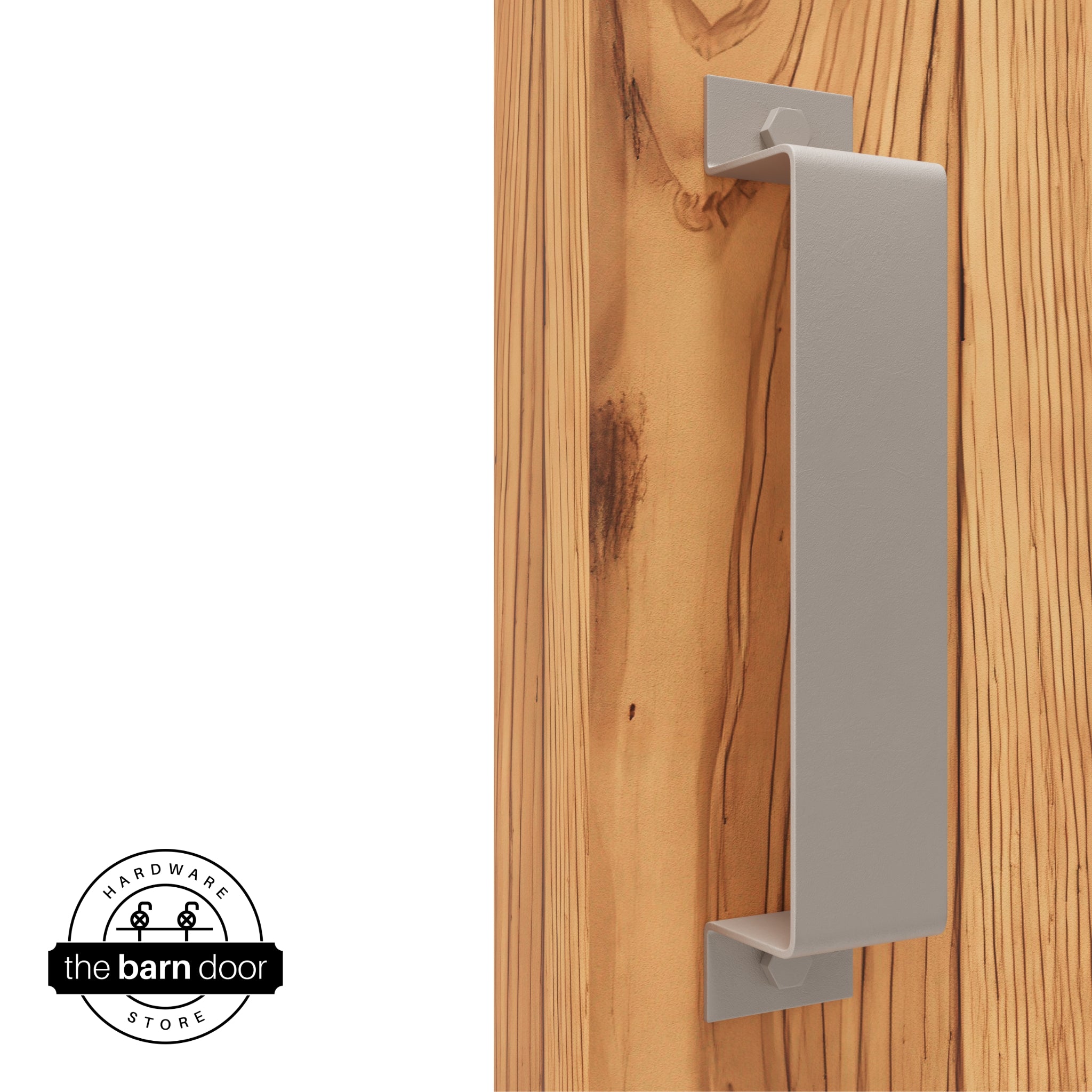 A white bronze, arch-shaped barn door handle is mounted on a light-colored wooden door with a vertical grain pattern.