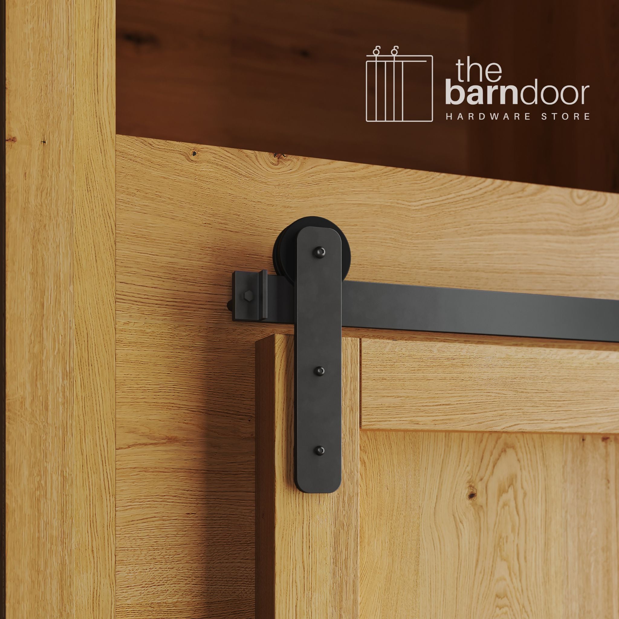 A close-up photograph of a natural oak cabinet with a sliding mini barn door, featuring an arch bronze straight-strap hanger and an arch bronze track system.
