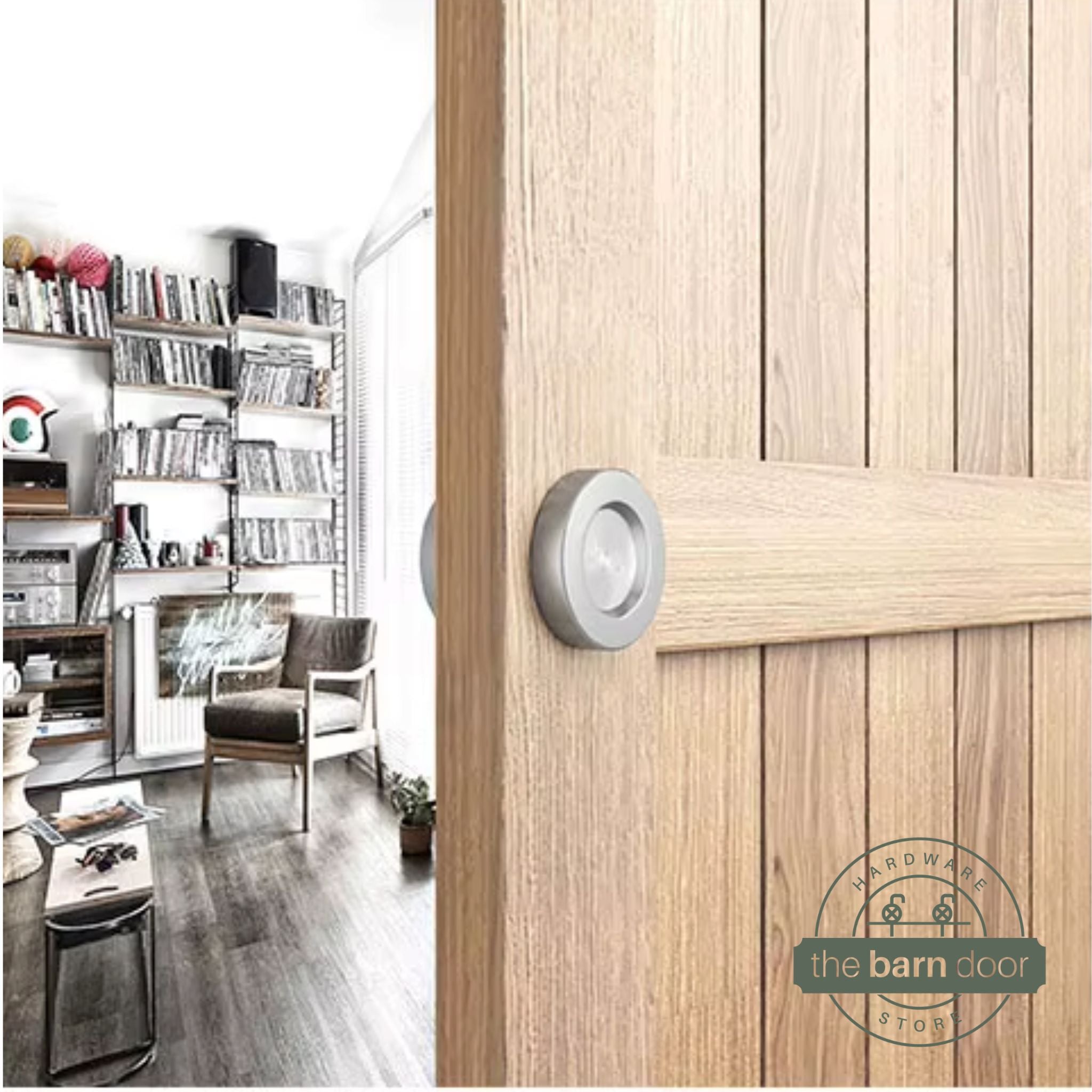 Stainless steel circular flush pull handle installed on a natural wood barn door in a living room setting
