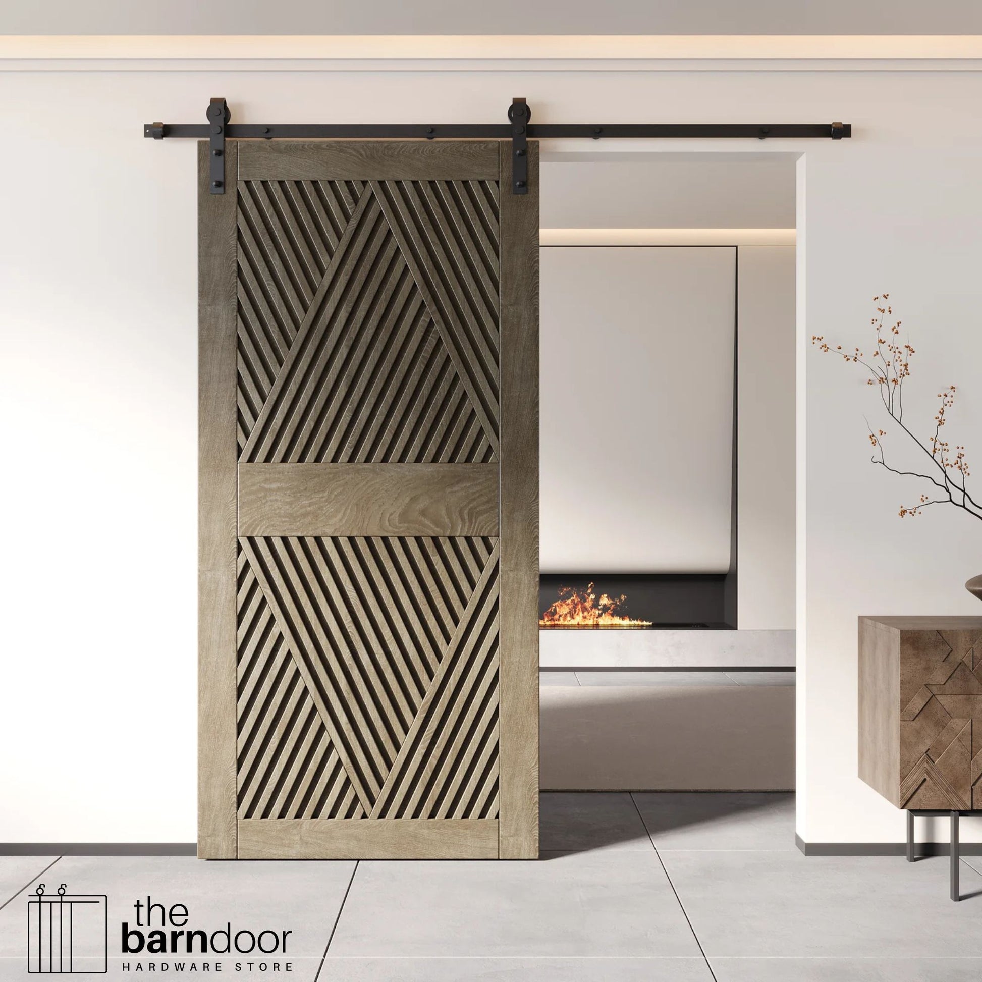 A modern classic gray barn door with an intricate geometric diamond pattern installed on a black track in a contemporary living space with a fireplace.