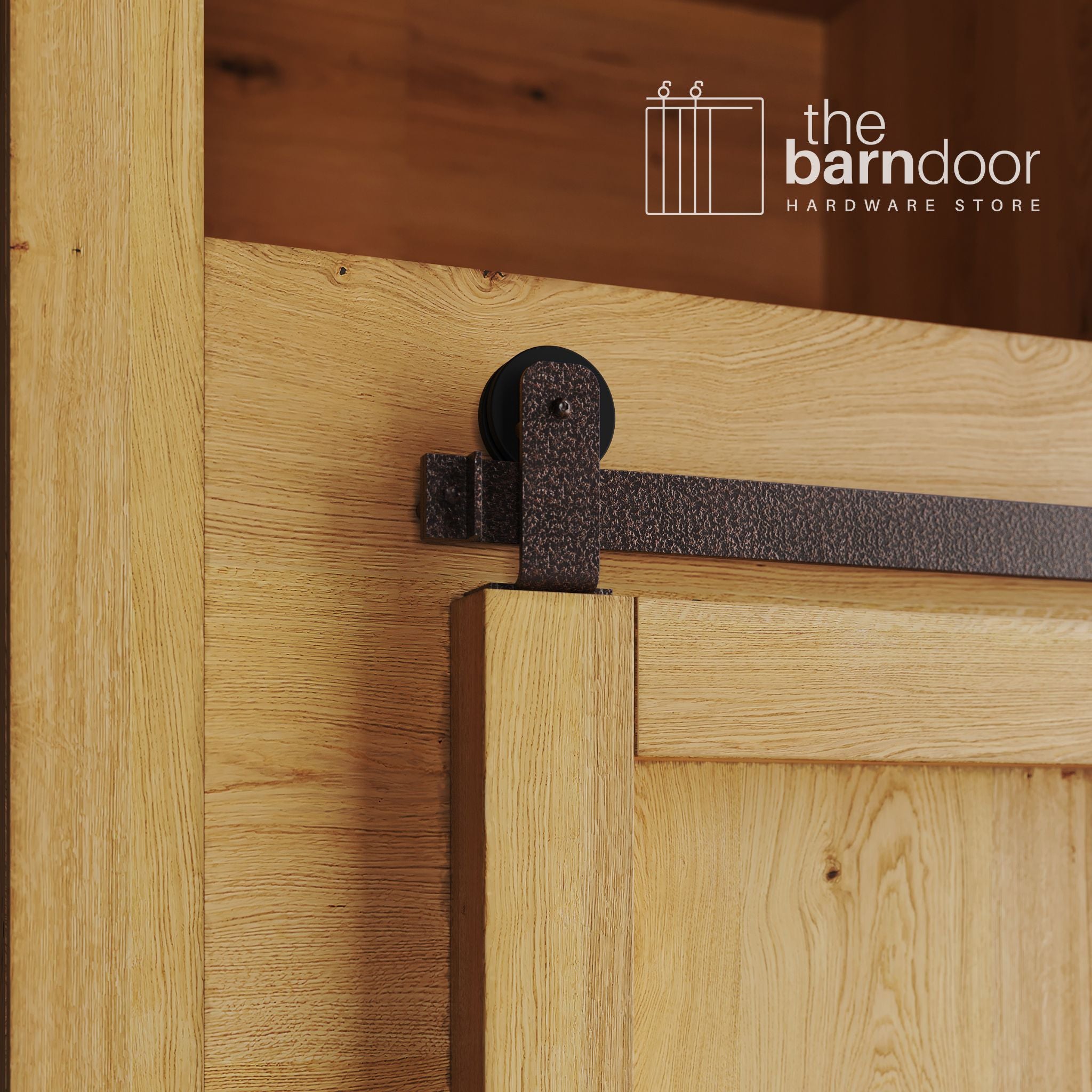 A close-up photograph of a sliding mini barn door on a natural oak cabinet, featuring copper vein top-mount straight hardware.