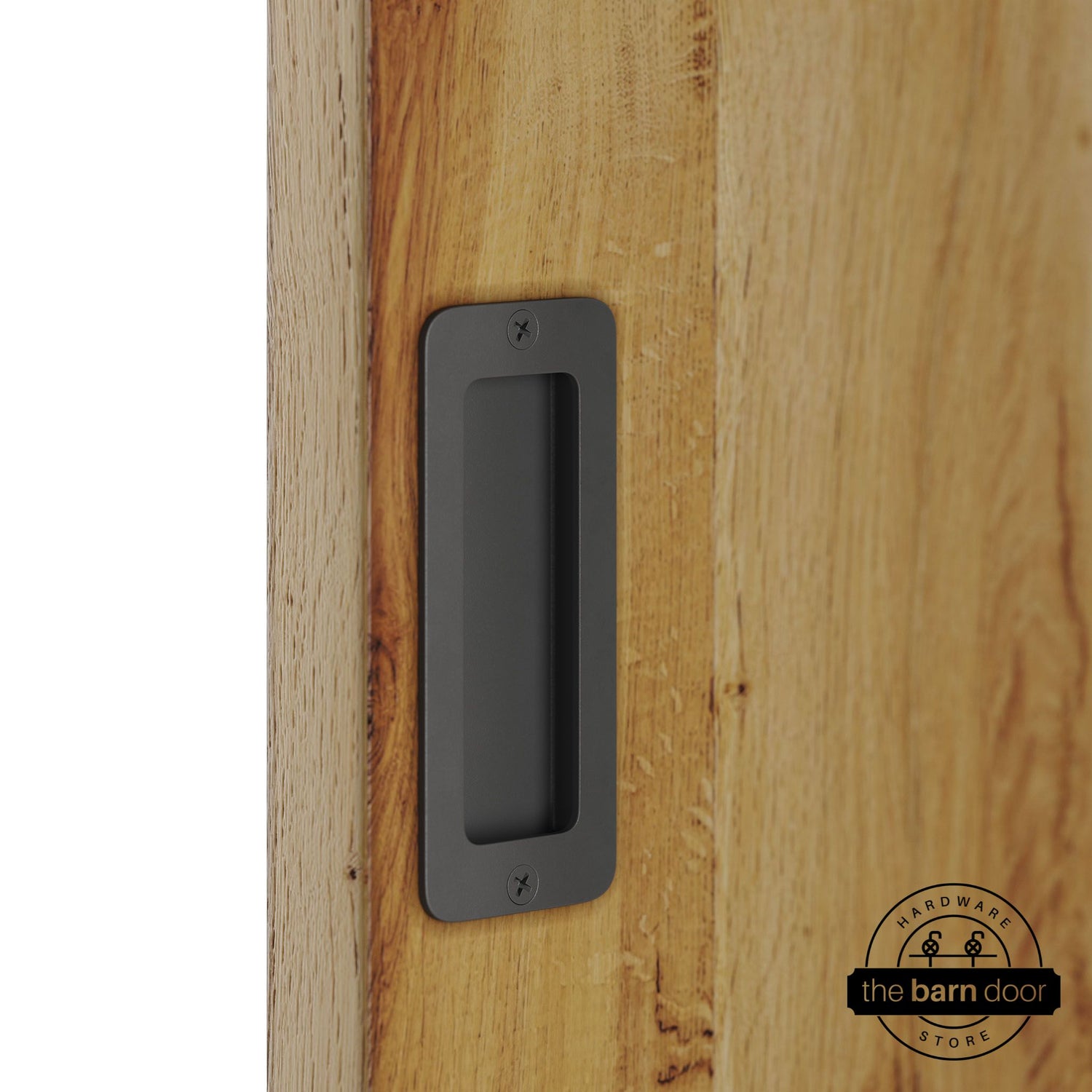 Dark gray partial radius flush pull handle for sliding barn doors, installed on natural wood door panel