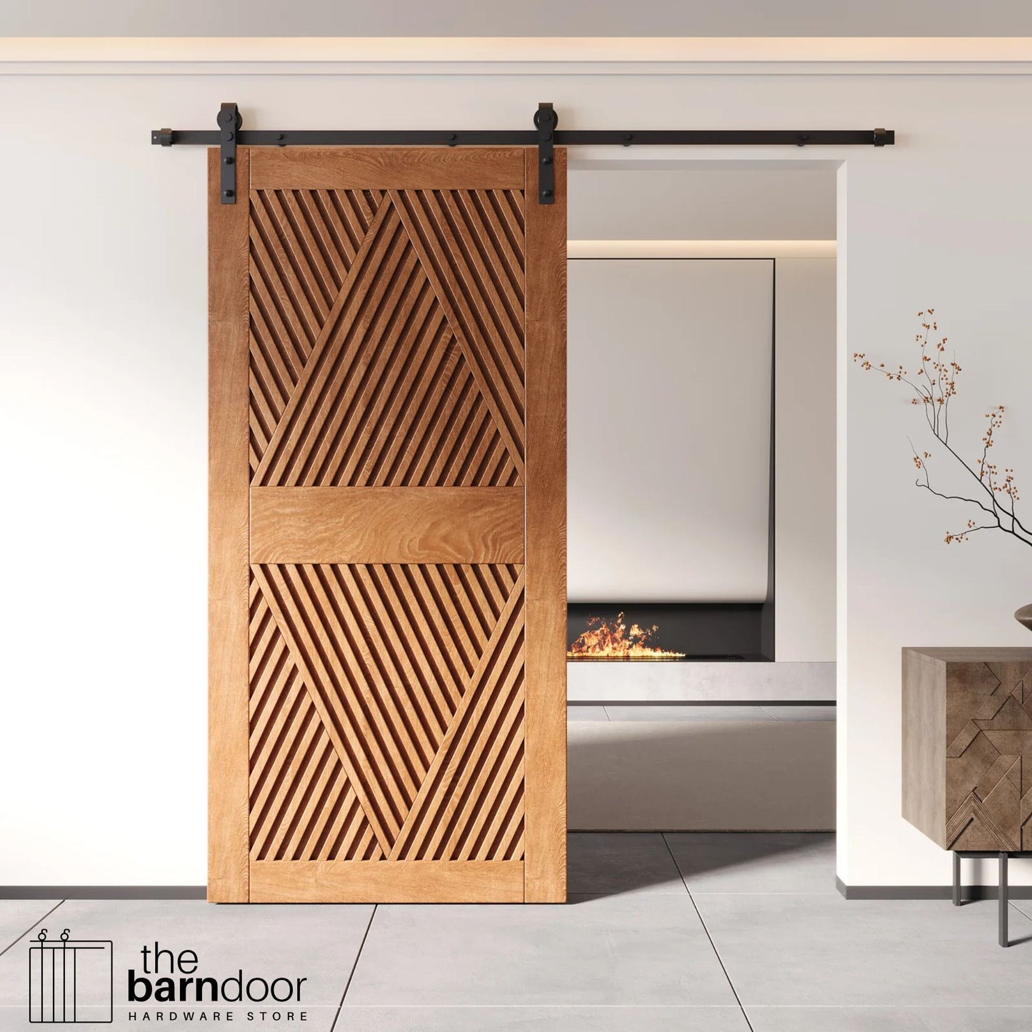 A modern Early American barn door with an intricate geometric diamond pattern installed on a black track in a contemporary living space with a fireplace.