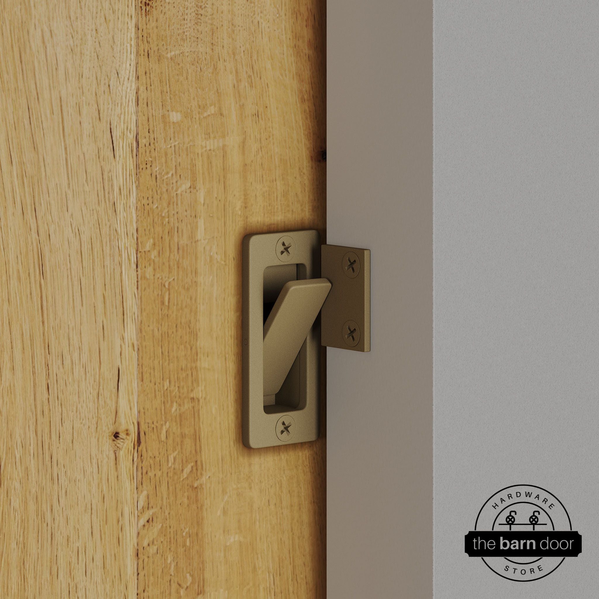 Gold privacy latch installed on a sliding barn door, shown in the locked position against door frame