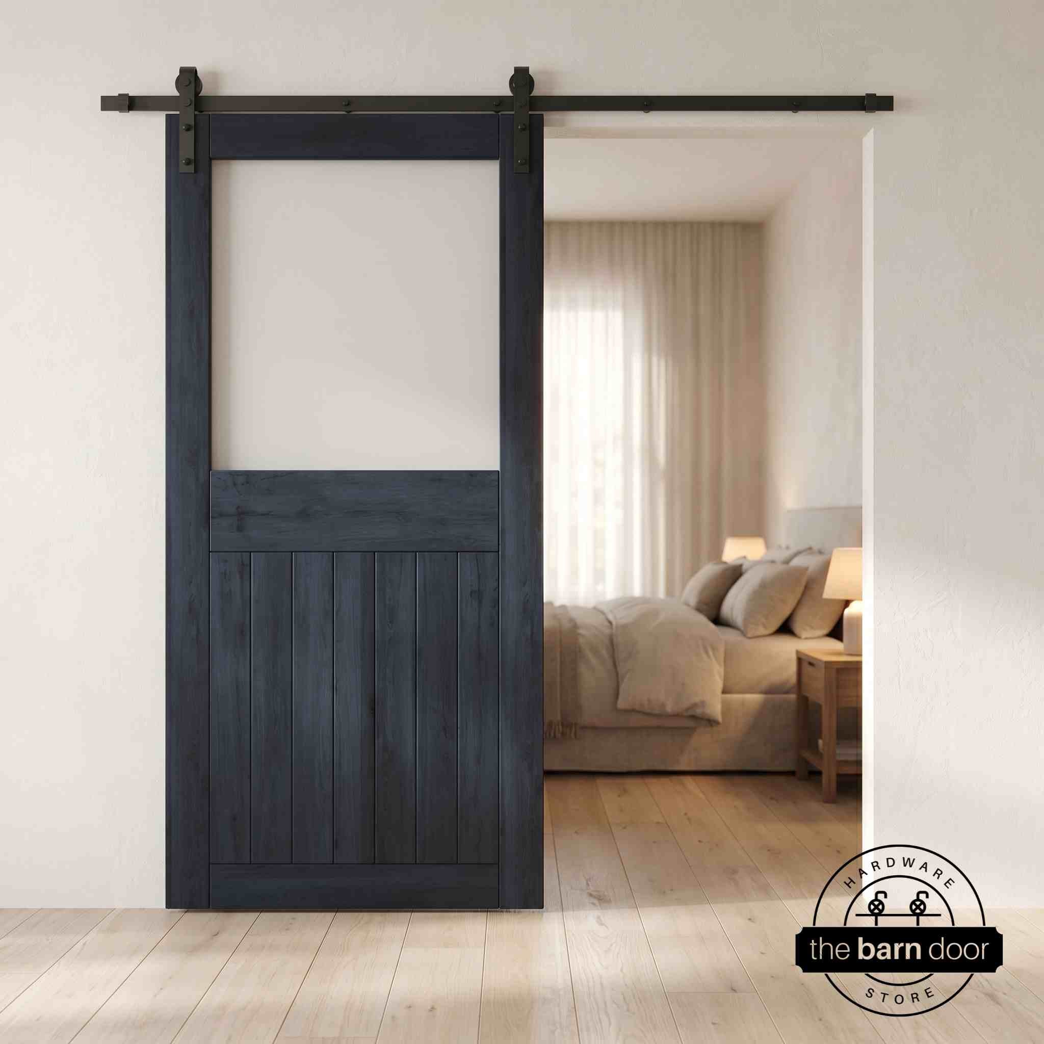 Navy sliding half-lite frosted glass barn door in a modern interior setting with a desk and shelves.