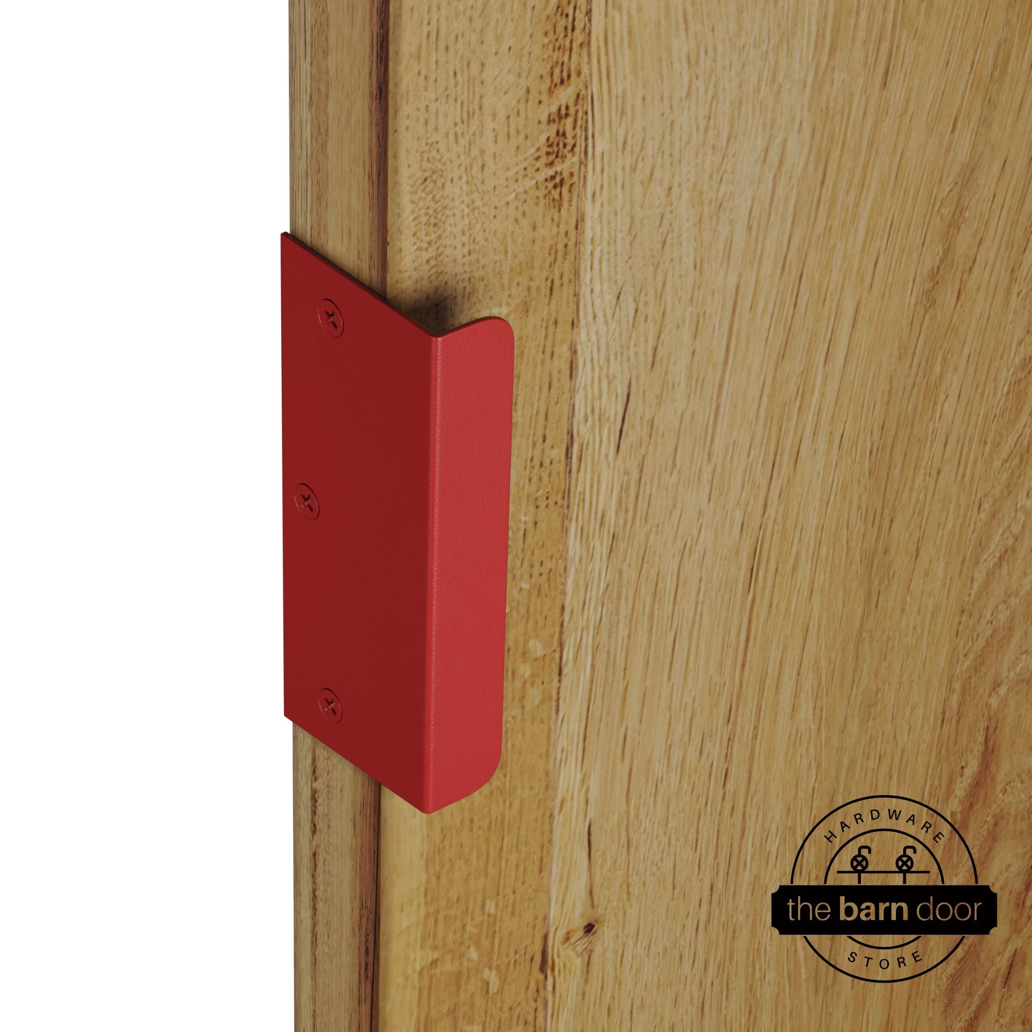 Red sliding barn door edge pull handle on natural wood door edge