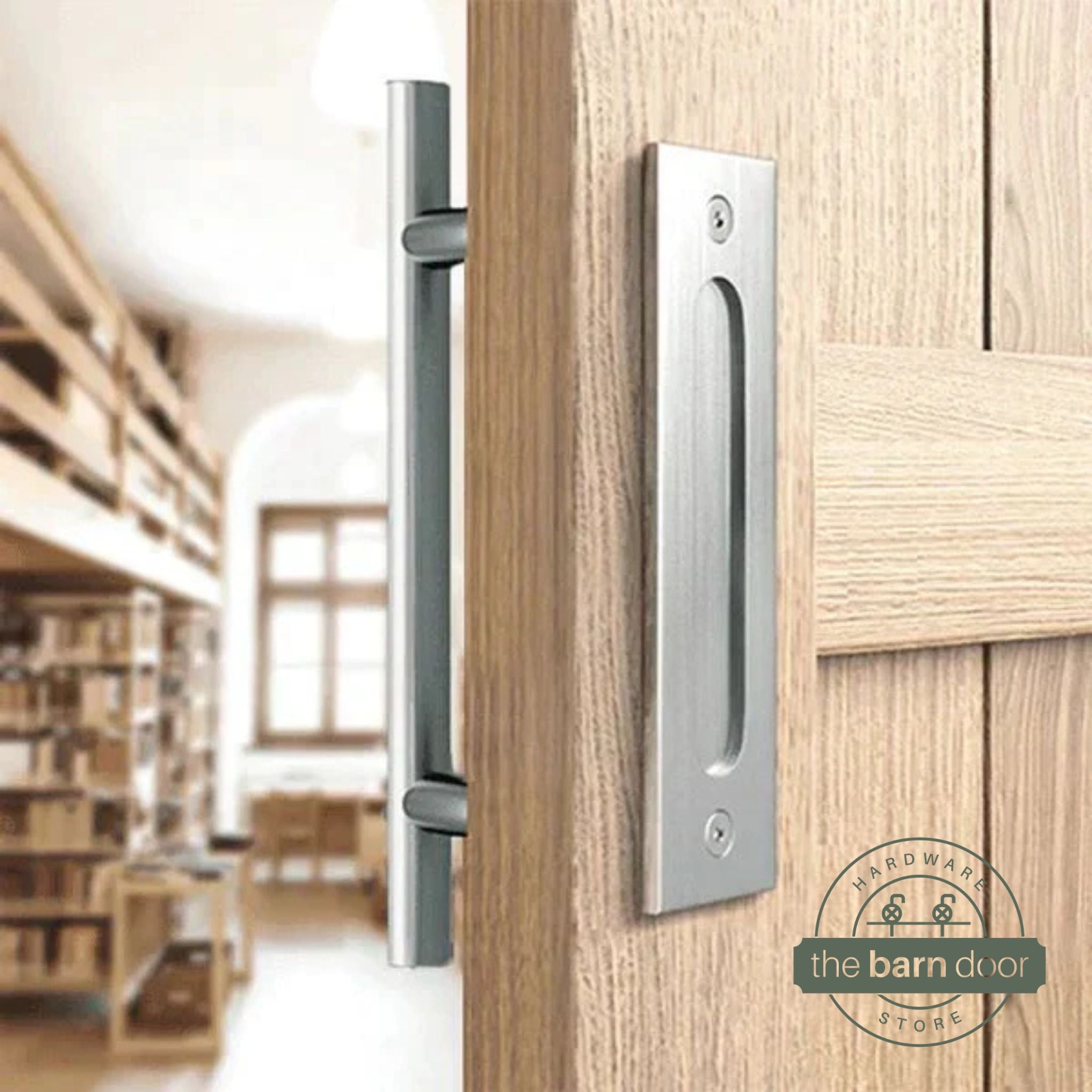Stainless steel round pull and flush handle set installed on a natural wood sliding barn door