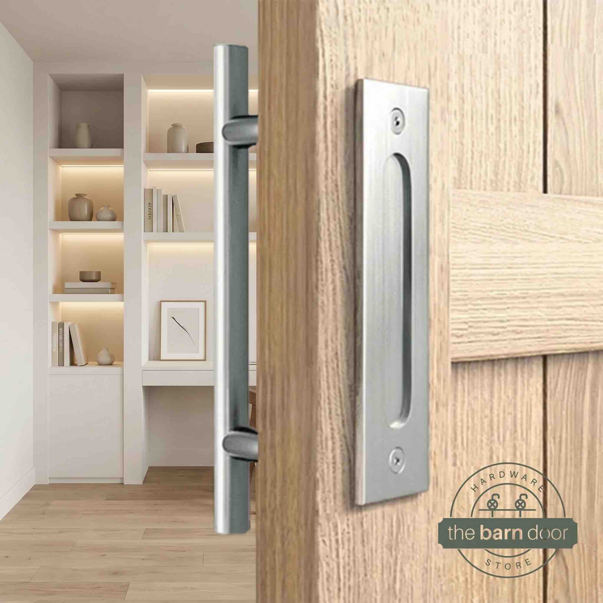 Stainless steel round pull and flush handle set installed on a natural wood sliding barn door