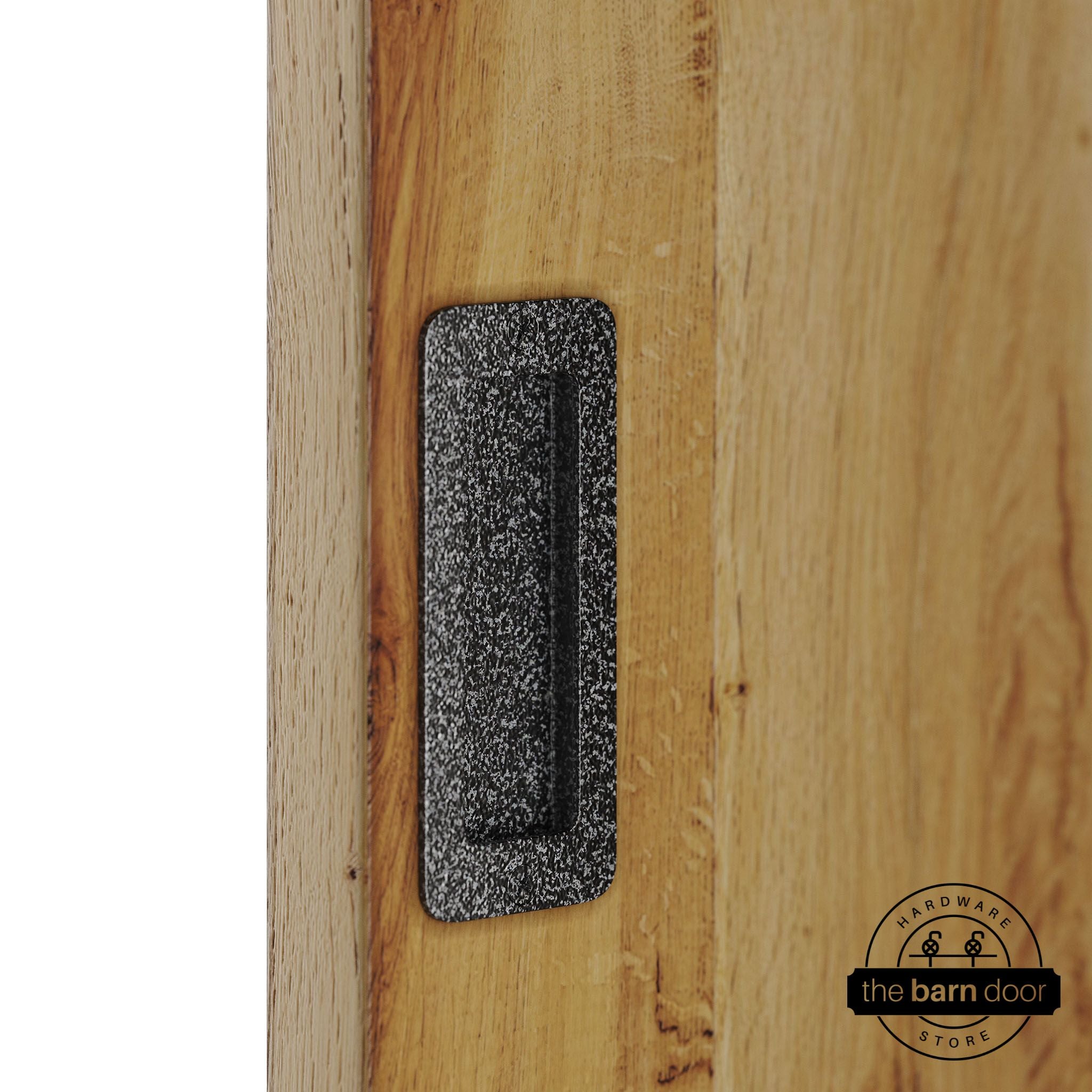 Silver vein partial radius flush pull handle for sliding barn doors, installed on natural wood door panel