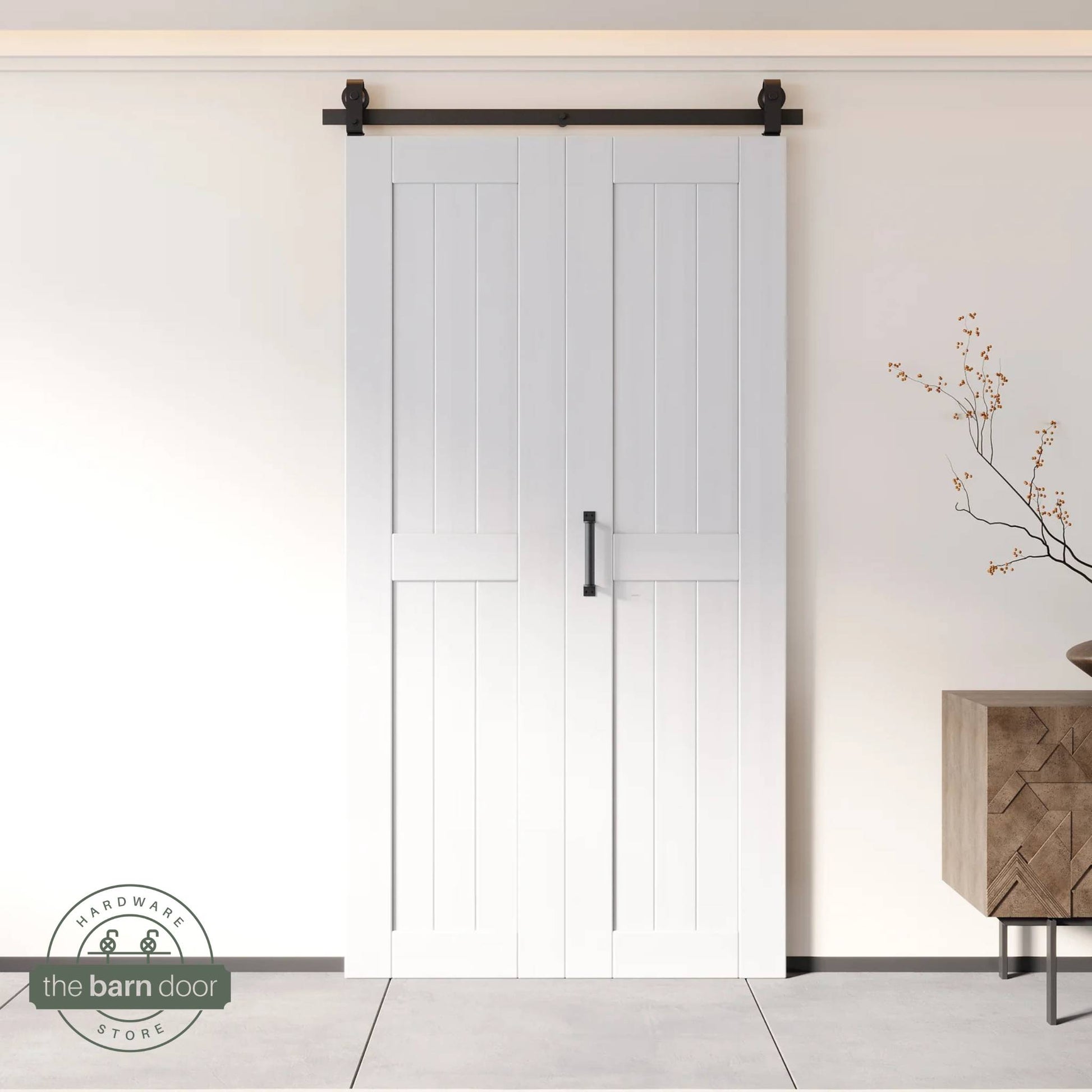 Two-panel bifold barn door in a white finish, installed and fully closed in a modern interior, showing the top-mount Matte Black track.
