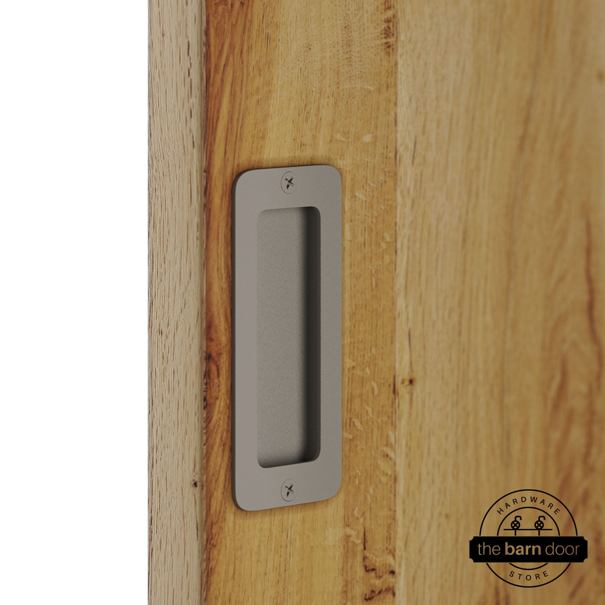 White bronze partial radius flush pull handle for sliding barn doors, installed on natural wood door panel