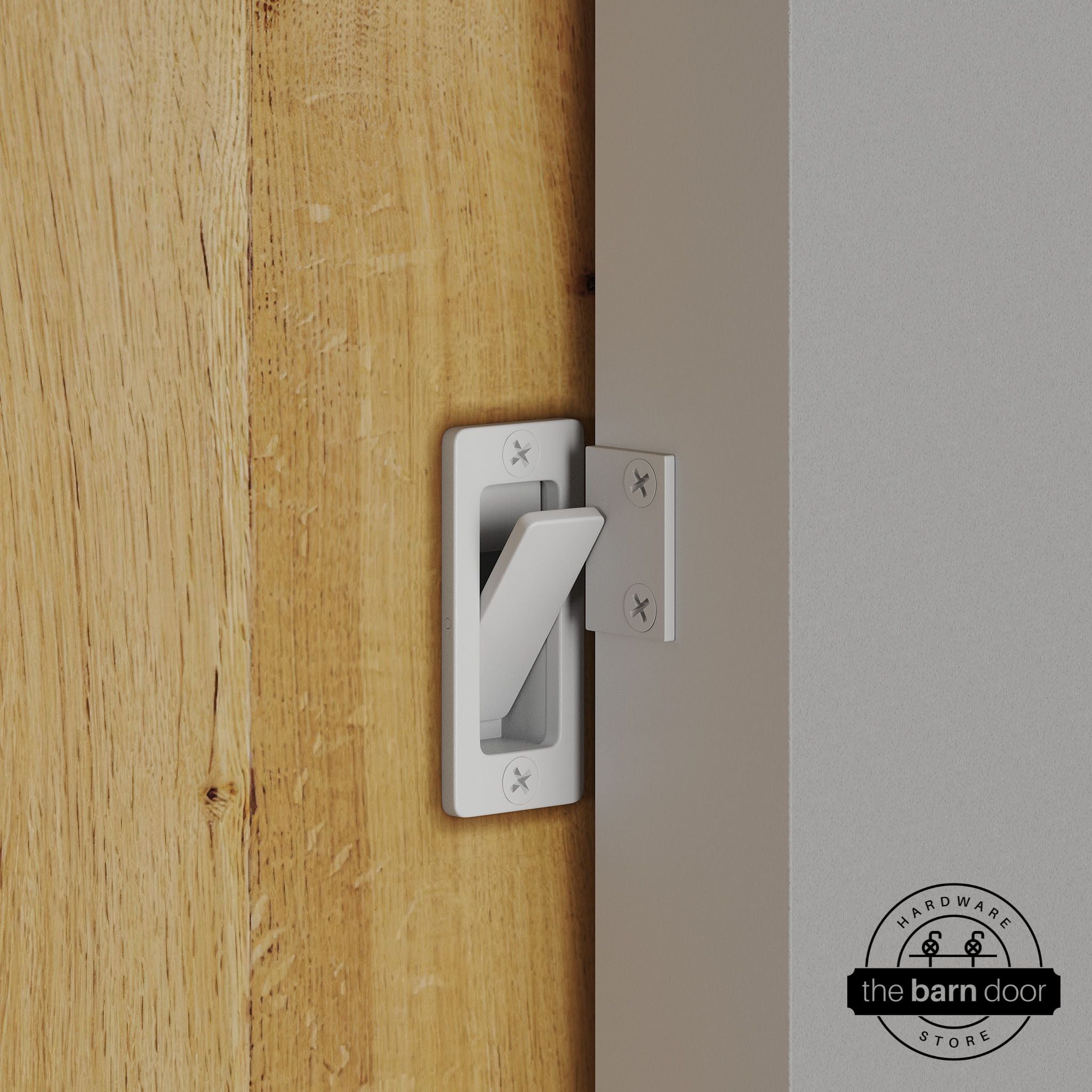 White privacy latch installed on a sliding barn door, shown in the locked position against door frame
