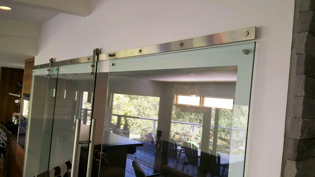Stainless Steel Barn Door Hardware Kit on a Glass Door