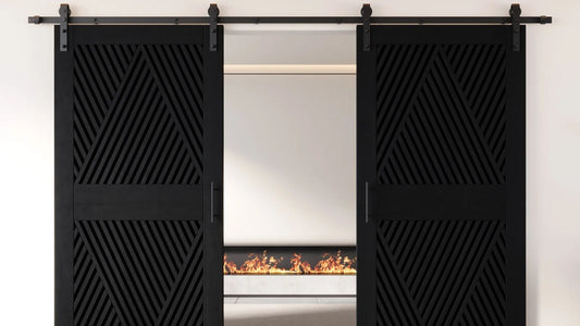 A symmetrical shot of two matte black sliding barn doors featuring a sophisticated geometric slatted pattern that forms triangular and diamond shapes.