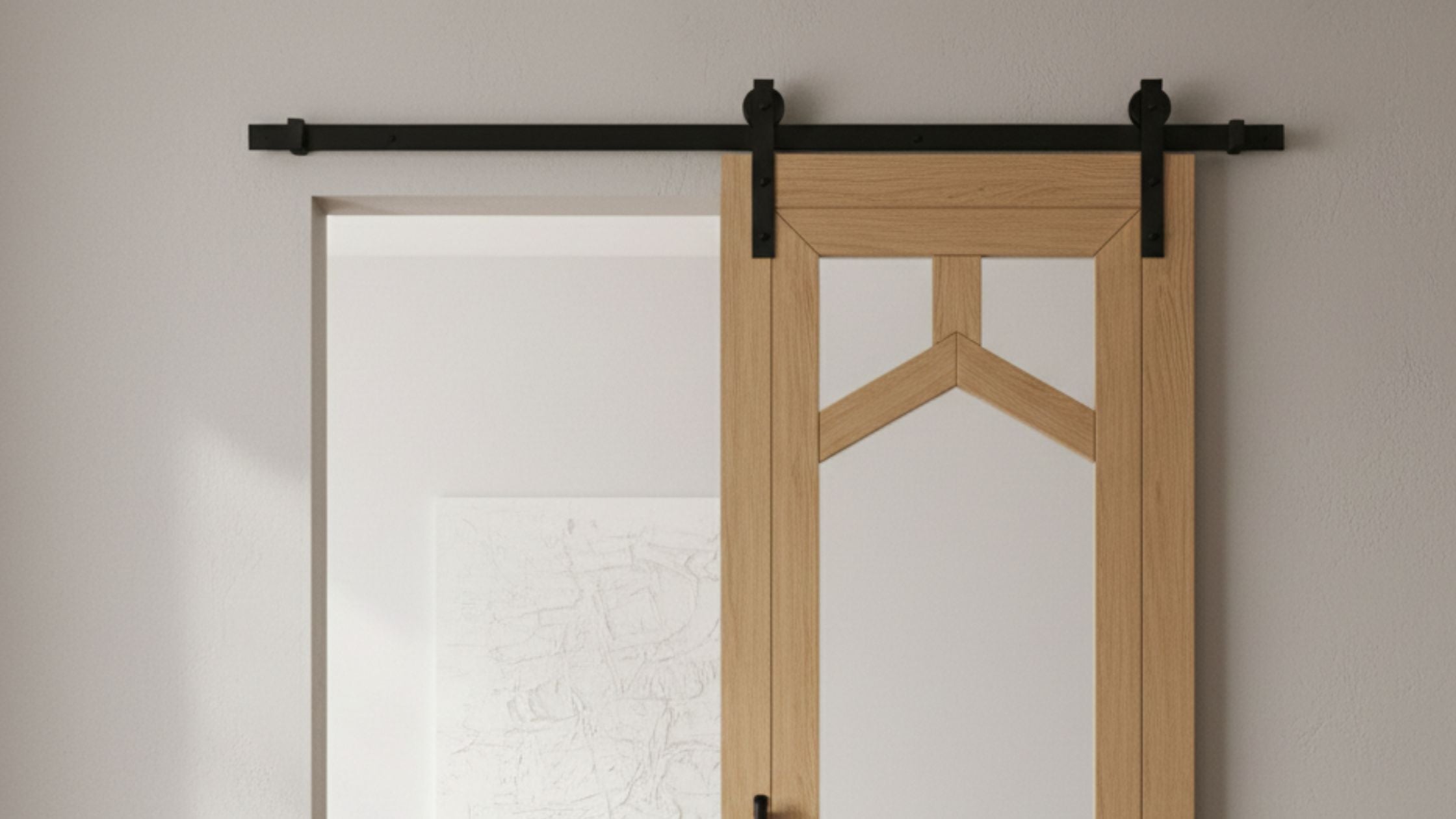 Modern geometric barn door with matte black straight strap hardware in a clean, minimalist home office setting.