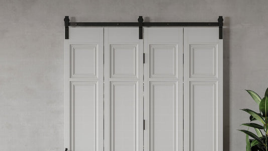 A set of four white, traditional paneled bifold doors mounted on a black industrial sliding track.