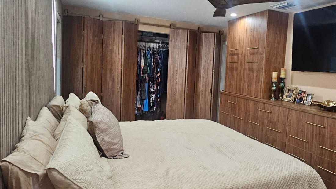 Jacob's Gold bifold barn door hardware on wood barn doors installed for a bedroom closet.