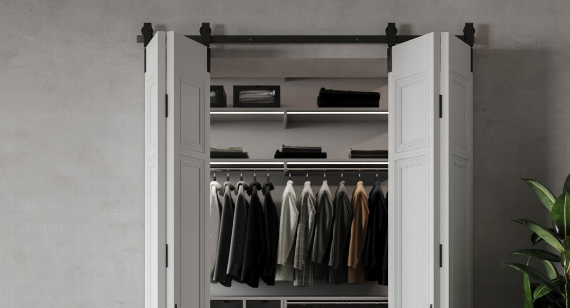 White barn doors leading to a closet, showcasing the clean aesthetic of 4 door bipating bifold barn door hardware.