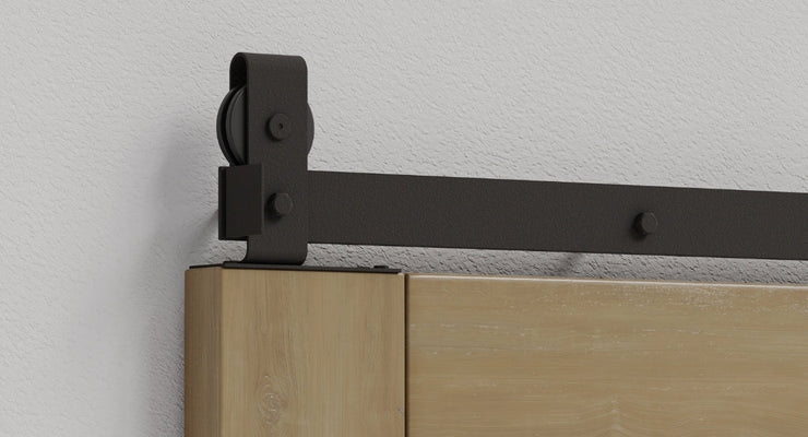 A close-up showcasing the solid steel construction and robust J-strap design of our heavy duty barn door hardware kits, made in the USA with a matte black finish.