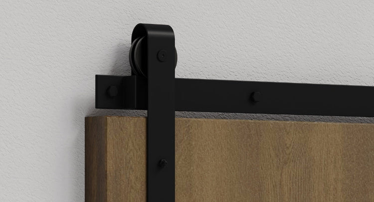 A close-up showcasing the classic J-strap design of our popular barn door hardware kit in a matte black finish.
