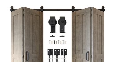 Partially open bi-fold barn door kit in a gray wood finish with black rolling hardware components displayed in the center.