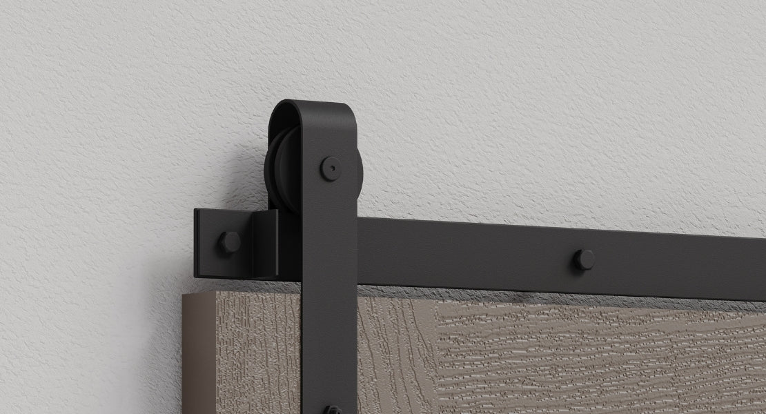 A selection of various barn door hardware kits, showcasing different styles like spoked wheel, J-strap, and top-mount in both black and brushed steel finishes.