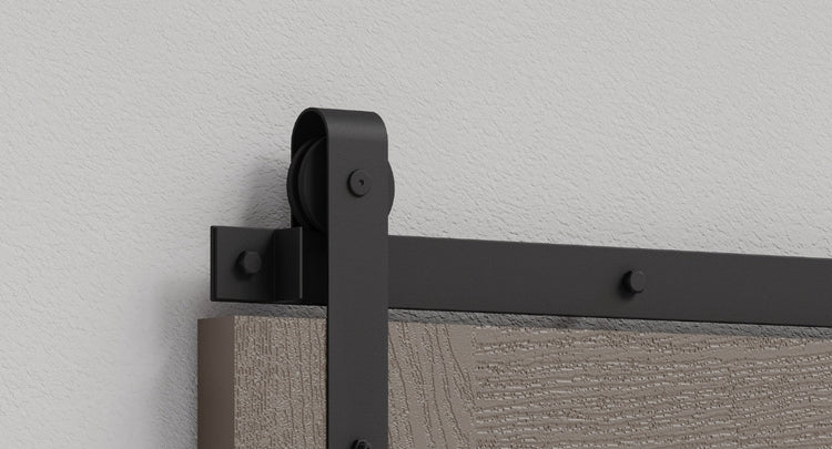 A selection of various barn door hardware kits, showcasing different styles like spoked wheel, J-strap, and top-mount in both black and brushed steel finishes.