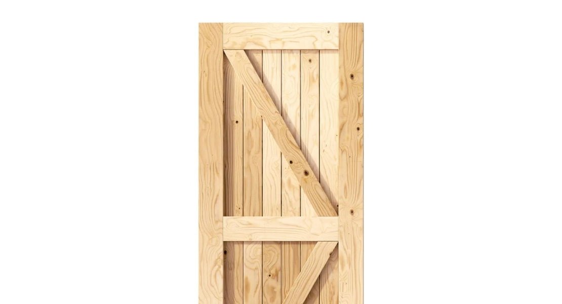 A close-up of a traditional wood barn door with an authentic X-brace design and natural unfinished pine construction.
