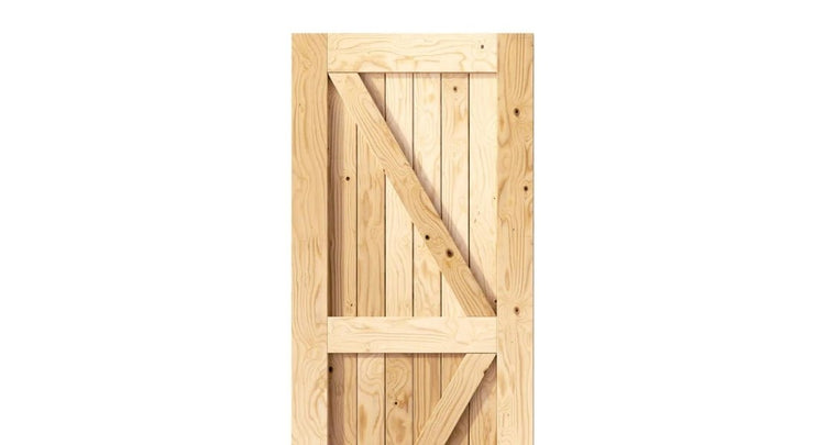 A close-up of a traditional wood barn door with an authentic X-brace design and natural unfinished pine construction.