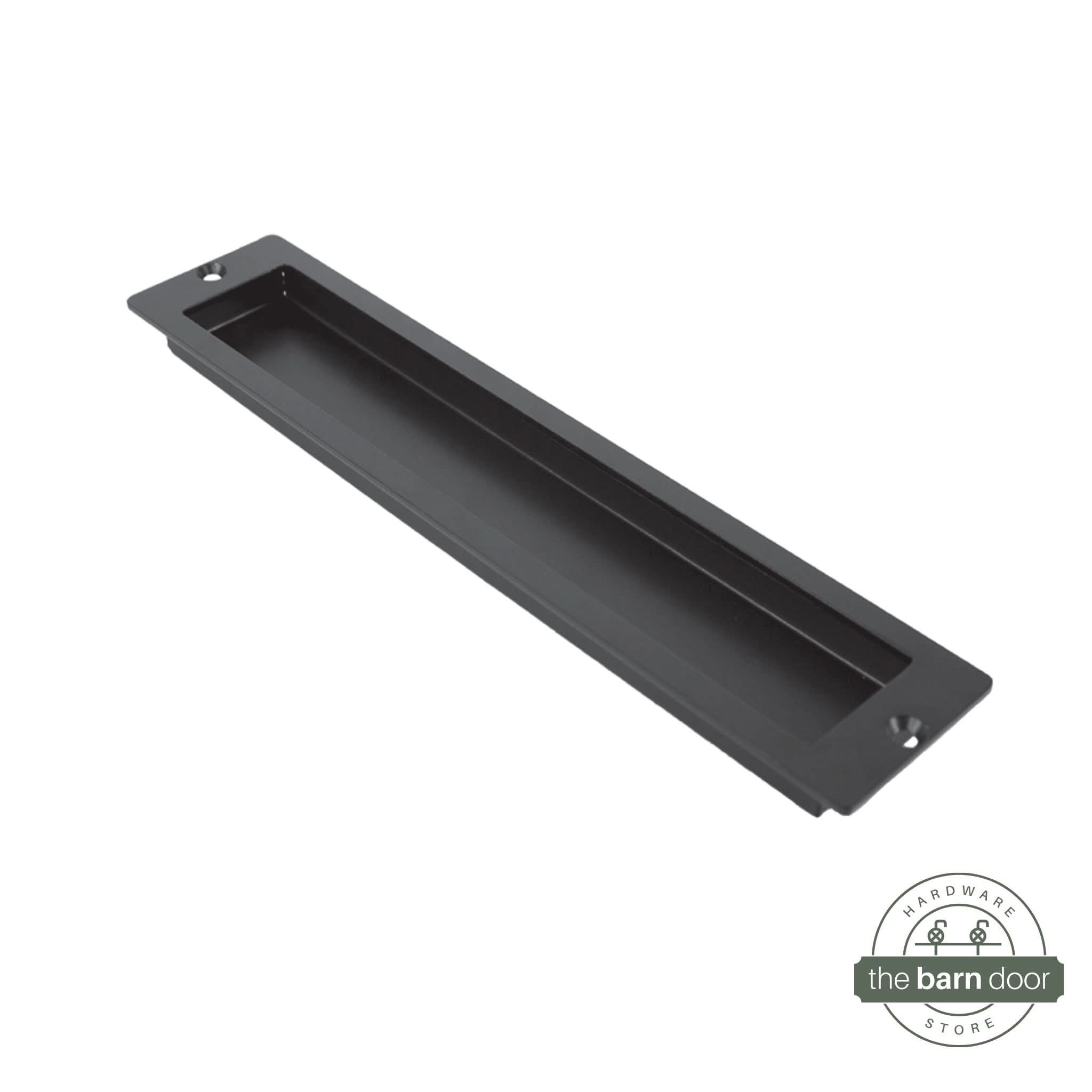 A close-up of a modern, rectangular flush pull handle with sharp, square corners, in a black finish.